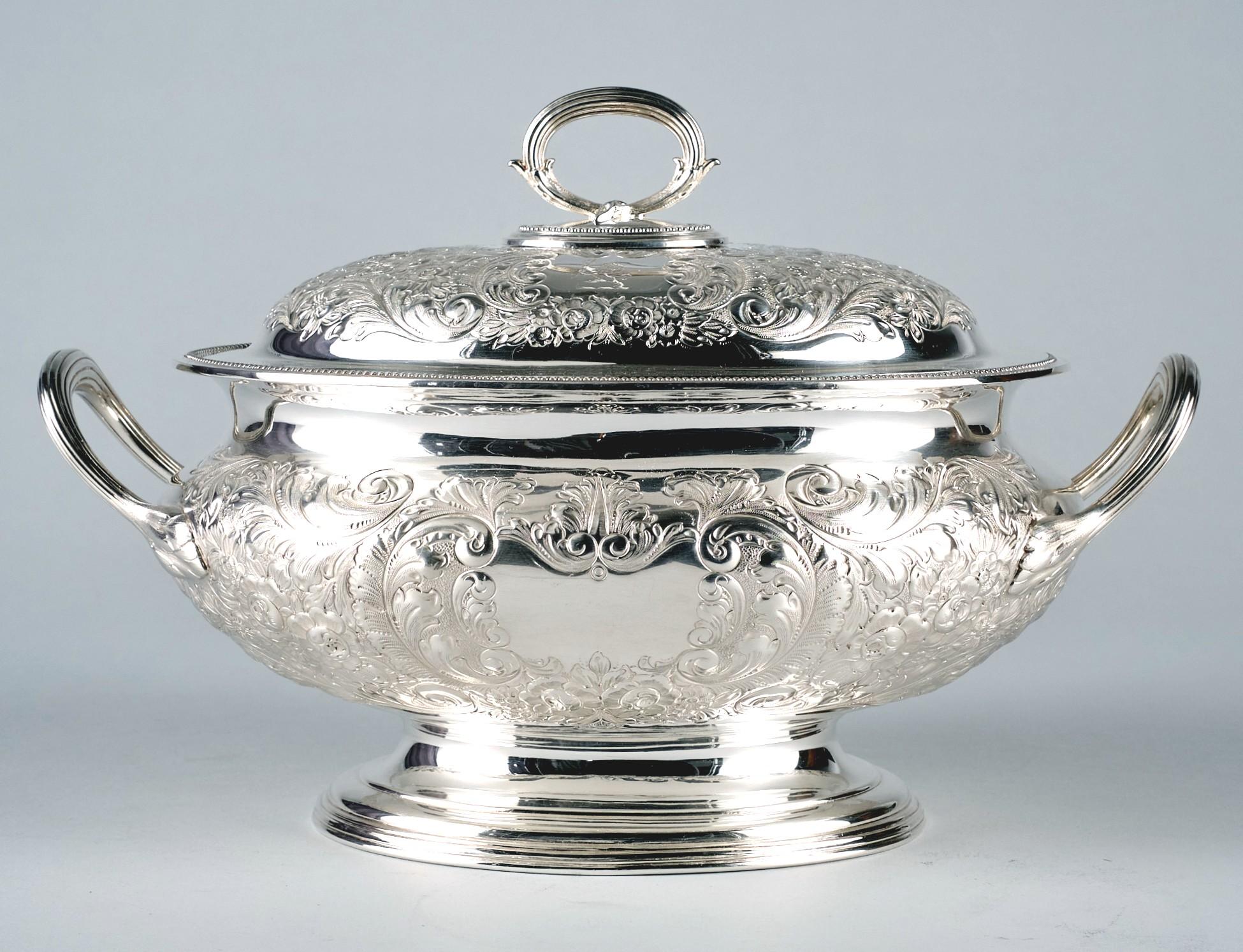 A very fine & impressively large silver plated soup tureen by Elkington & Company of London with a capacity to hold 4 quarts. 
The substantial oval body having open handles, richly decorated with embossed & engraved foliate motifs & centered by