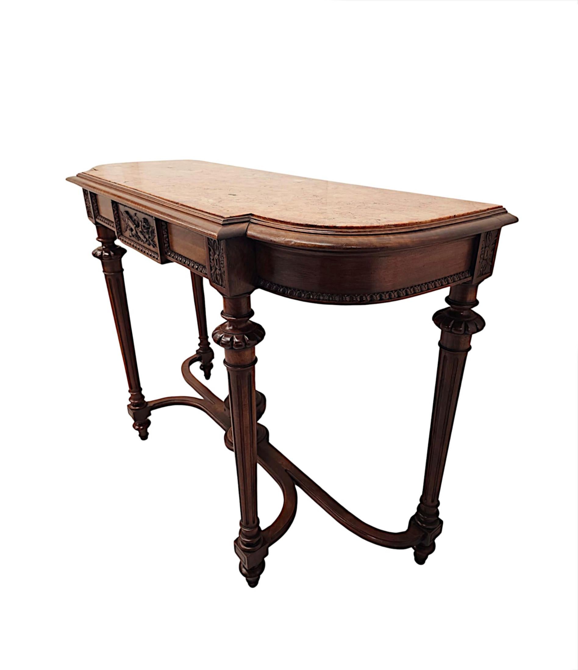 A very fine 19th Century well figured walnut marble top console table, superbly hand carved and of exceptional quality with gorgeously rich patination and fine grain.  The fabulous moulded and shaped Emperador marble top of rectangular form is