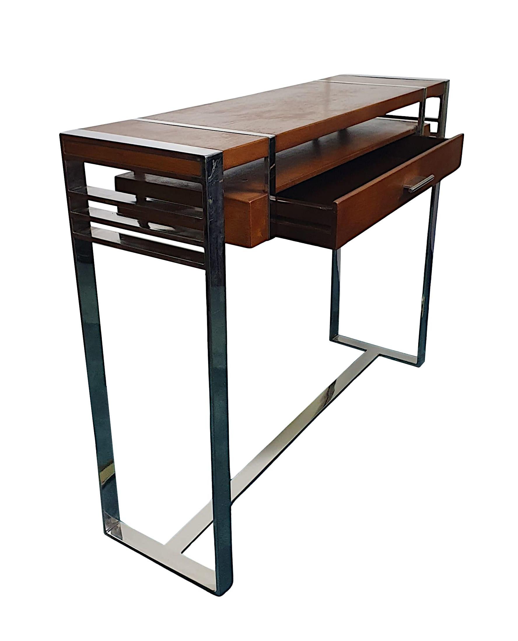 Una mesa consola de madera de cerezo ricamente patinada, de diseño Art Decó del siglo XX, de proporciones cuidadas, fabulosa calidad y finamente tallada, con un diseño limpio y sencillo.  La tapa, bien labrada y con molduras cromadas, se eleva sobre