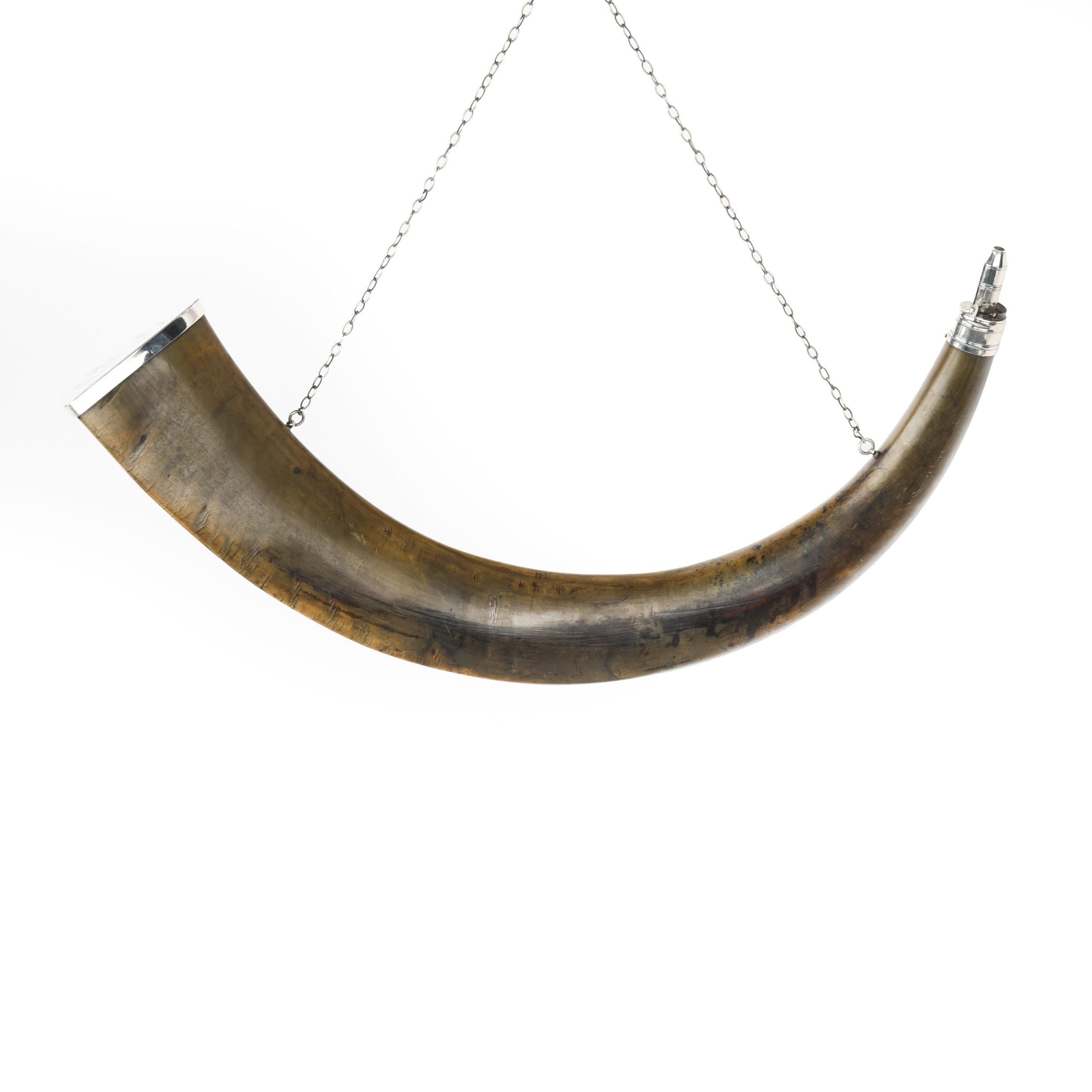 This fine powder horn has silver mounts by the silversmiths Thomas Phipps and Edward Robinson, hallmarked for London, 1803. The charger on the horn has three adjustments and a side lever system and the wider end of the horn has a silver cap engraved