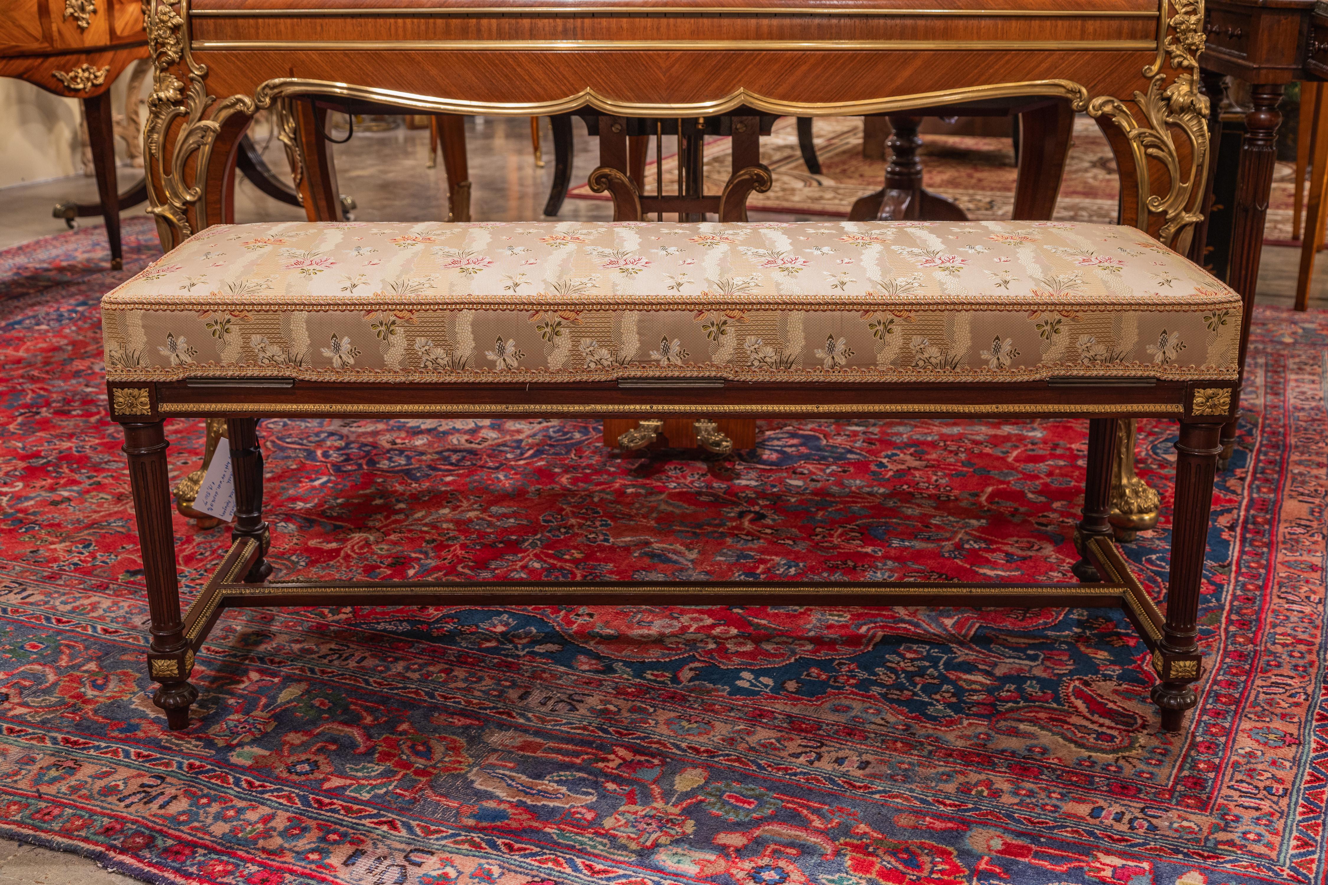 A very fine 19th century Louis XVI mahogany and gilt bronze mounted bench . The bench opens for storage. Could be used as a piano bench for a Grand Piano  or in front of a French bed 