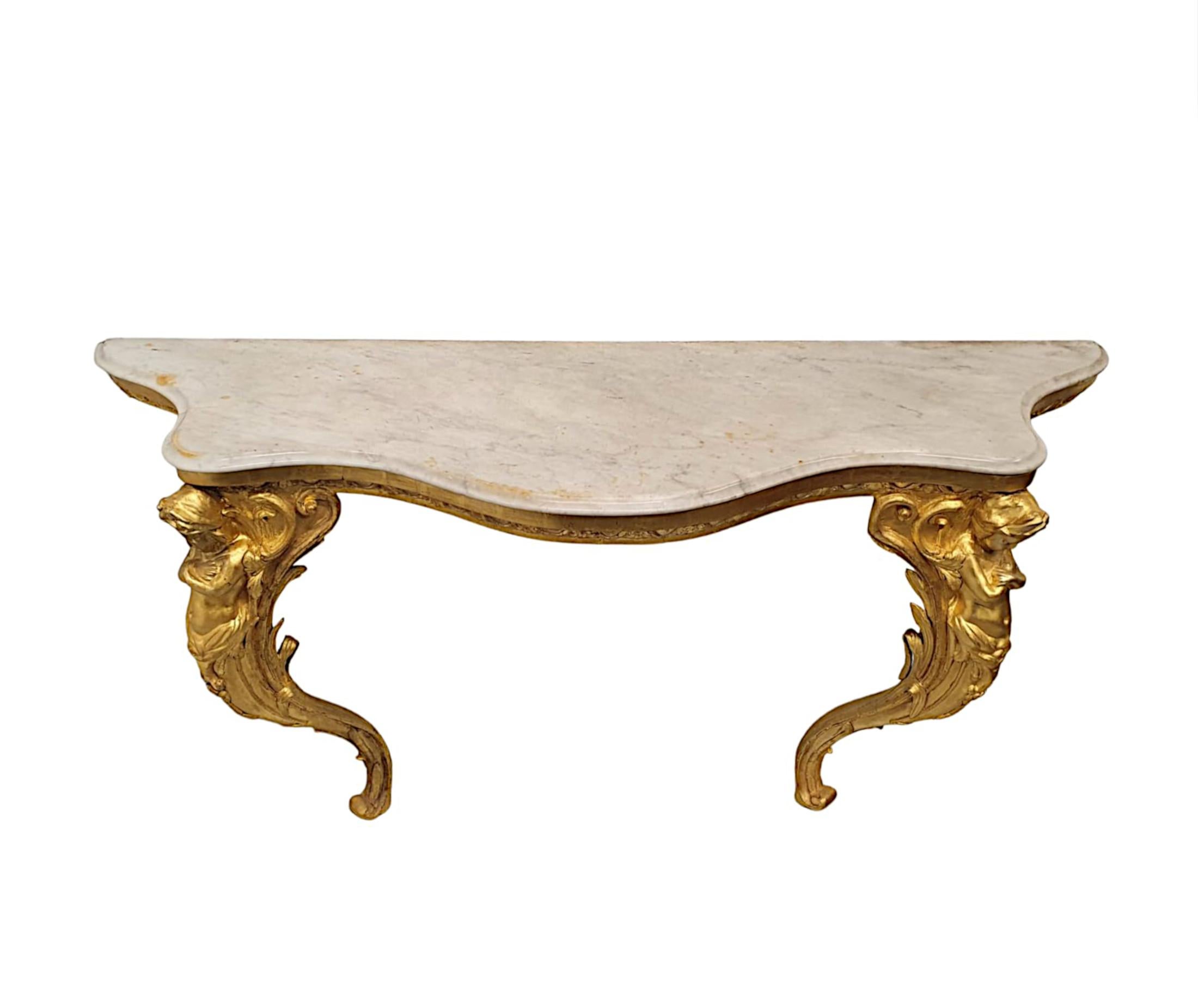 A very fine and rare 19th Century marble top giltwood console table, finely hand carved and of exceptional quality.  The gorgeous moulded Carrera white marble top of serpentine form raised over frieze with decorative foliate and egg motifs,