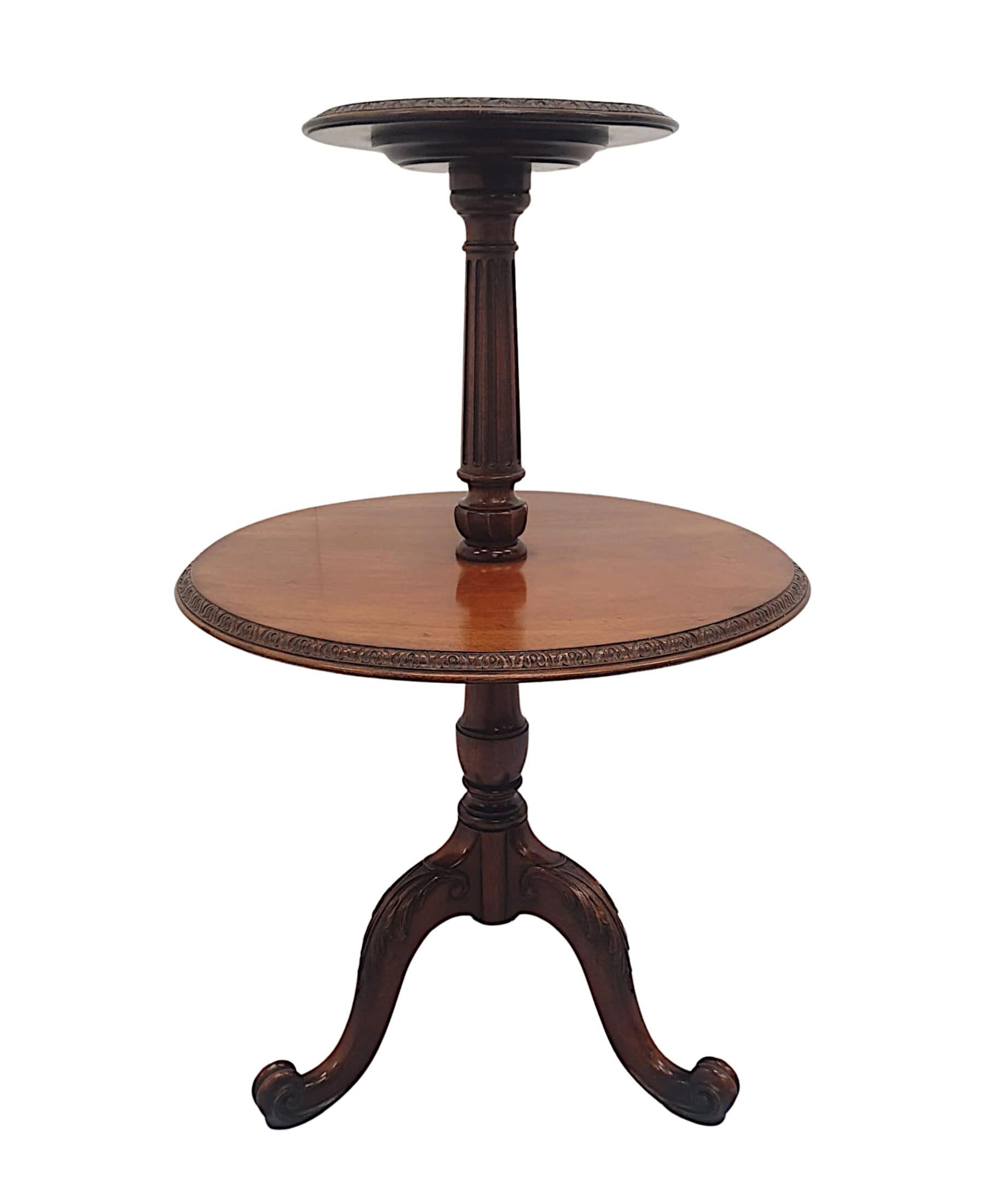 A very fine and rare 19th Century mahogany two tier wine or occasional table of circular form, exceptional quality and beautifully hand carved with rich patination and grain.  The moulded, well figured top tier with gorgeous carved border detail is