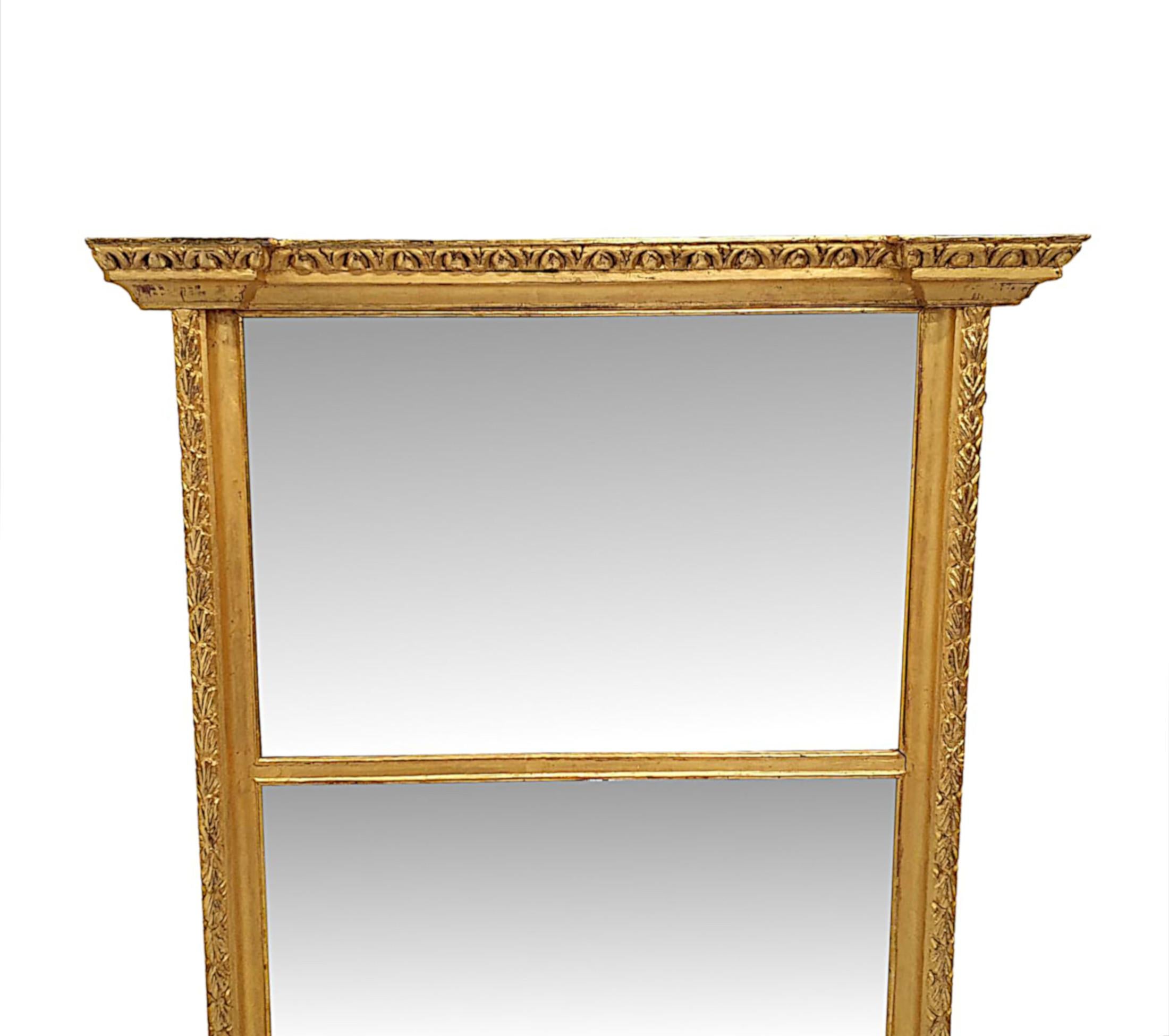A very fine and unusual 19th Century compartmental overmantle mirror.  The two mirror glass plates of rectangular form are set within a fabulously hand carved moulded and reeded giltwood frame surmounted with a breakfront stepped overhanging cornice