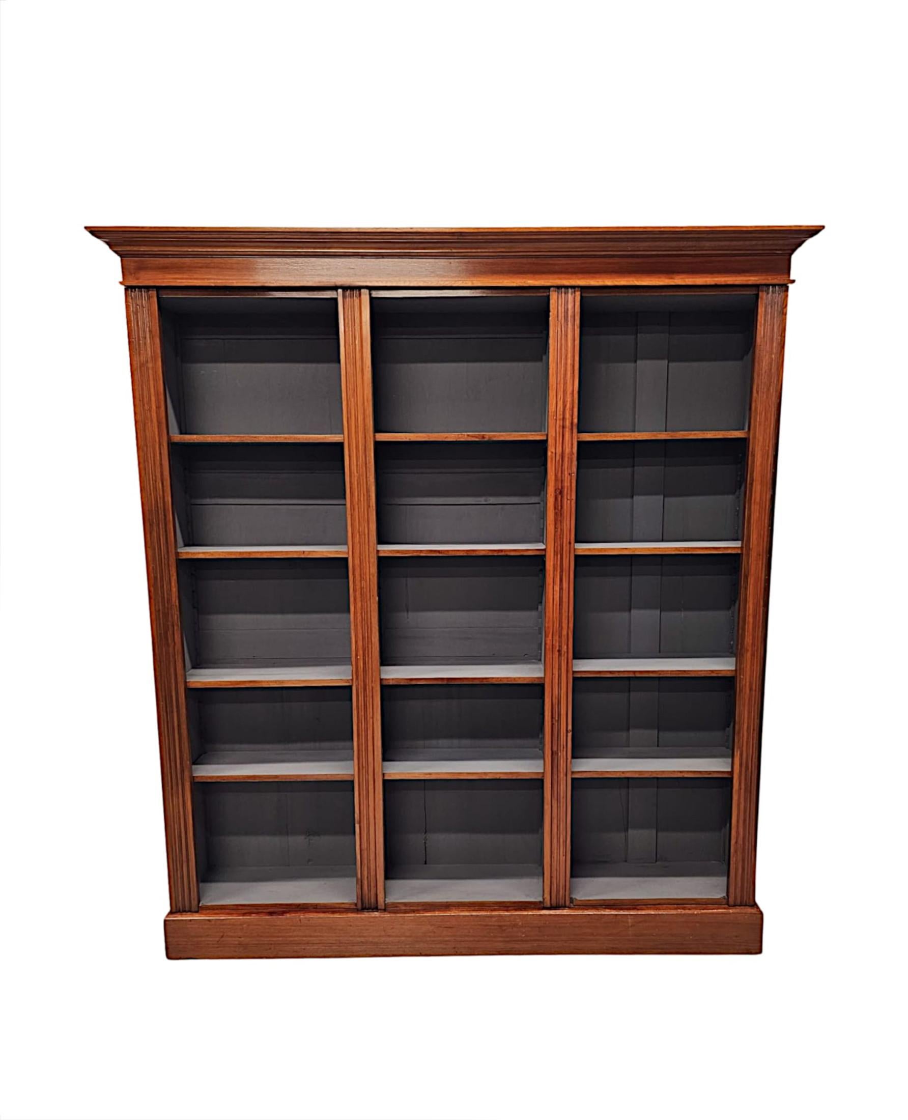 A very fine and unusual, well figured walnut 19th Century open bookcase of large proportions, superbly hand carved and of exceptional quality with gorgeously rich patination and fine grain.  The moulded top of rectangular form with reeded