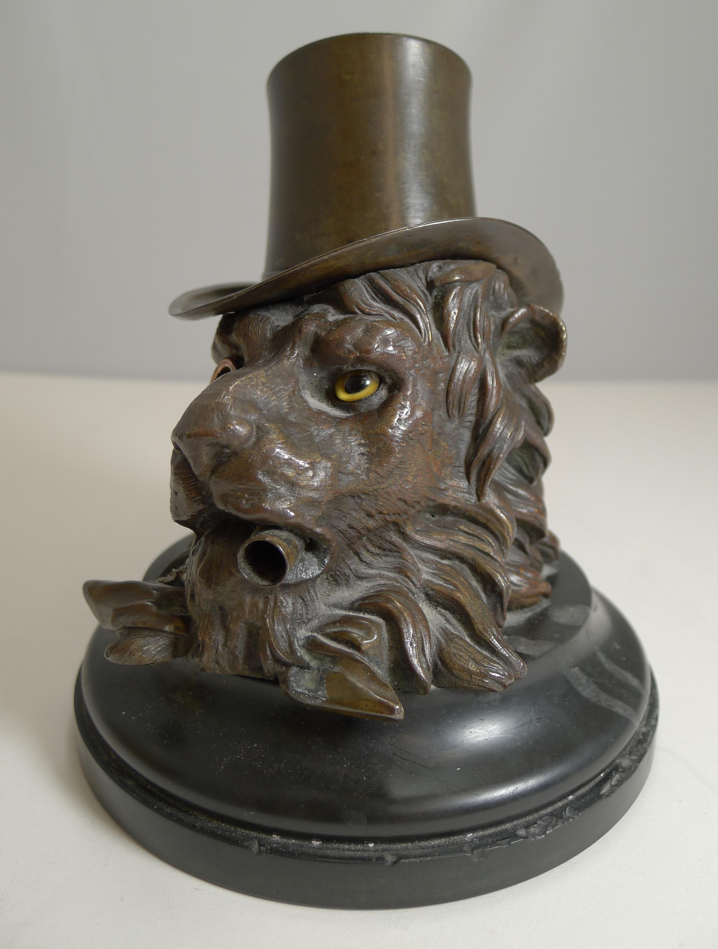 A truly magnificent and rare English Victorian bronze inkwell beautifully executed in the form of a very dapper and handsome Lion.

Standing on a black marble plinth, the handsome Lion wears a top hat and sports his monocle on a chain. Retaining