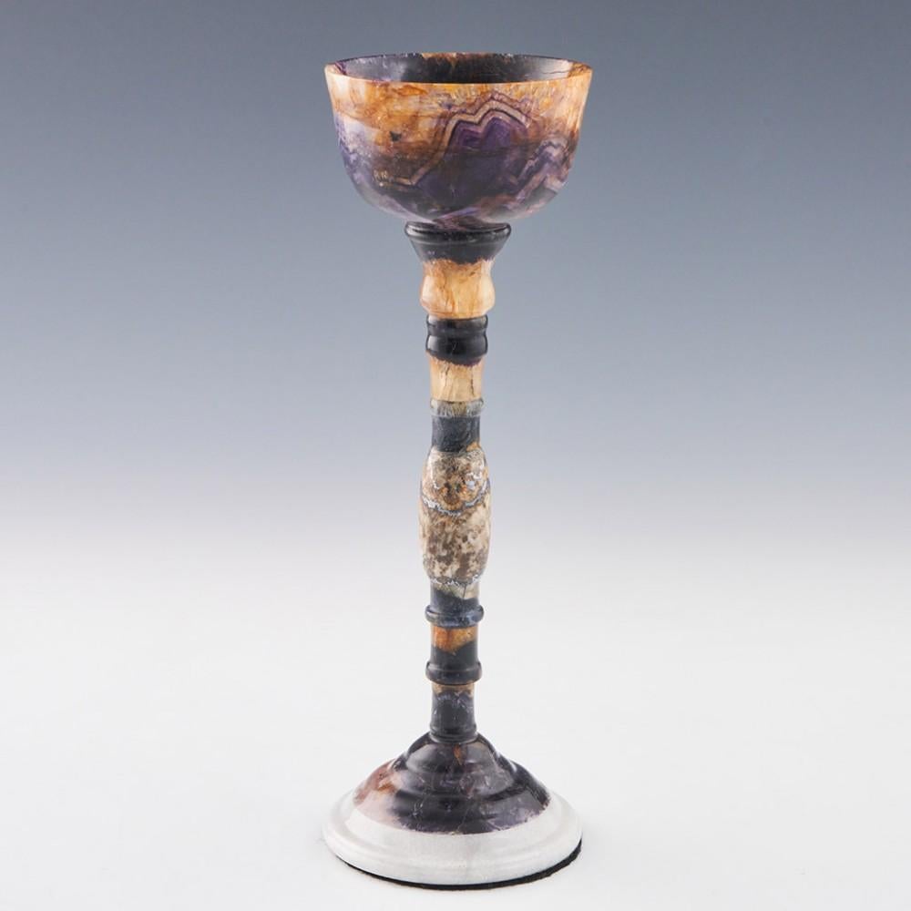 Heading : A Very Fine Blue John Chalice Old Tor Vein
Period : Elizabeth II-late 20th Century
Origin : Derbyshire
Colour : Blue, cream, pale brown, silver and silver grey
Bowl : Cup shaped made from Blue John extracted from Old Tor Vein
Stem : A