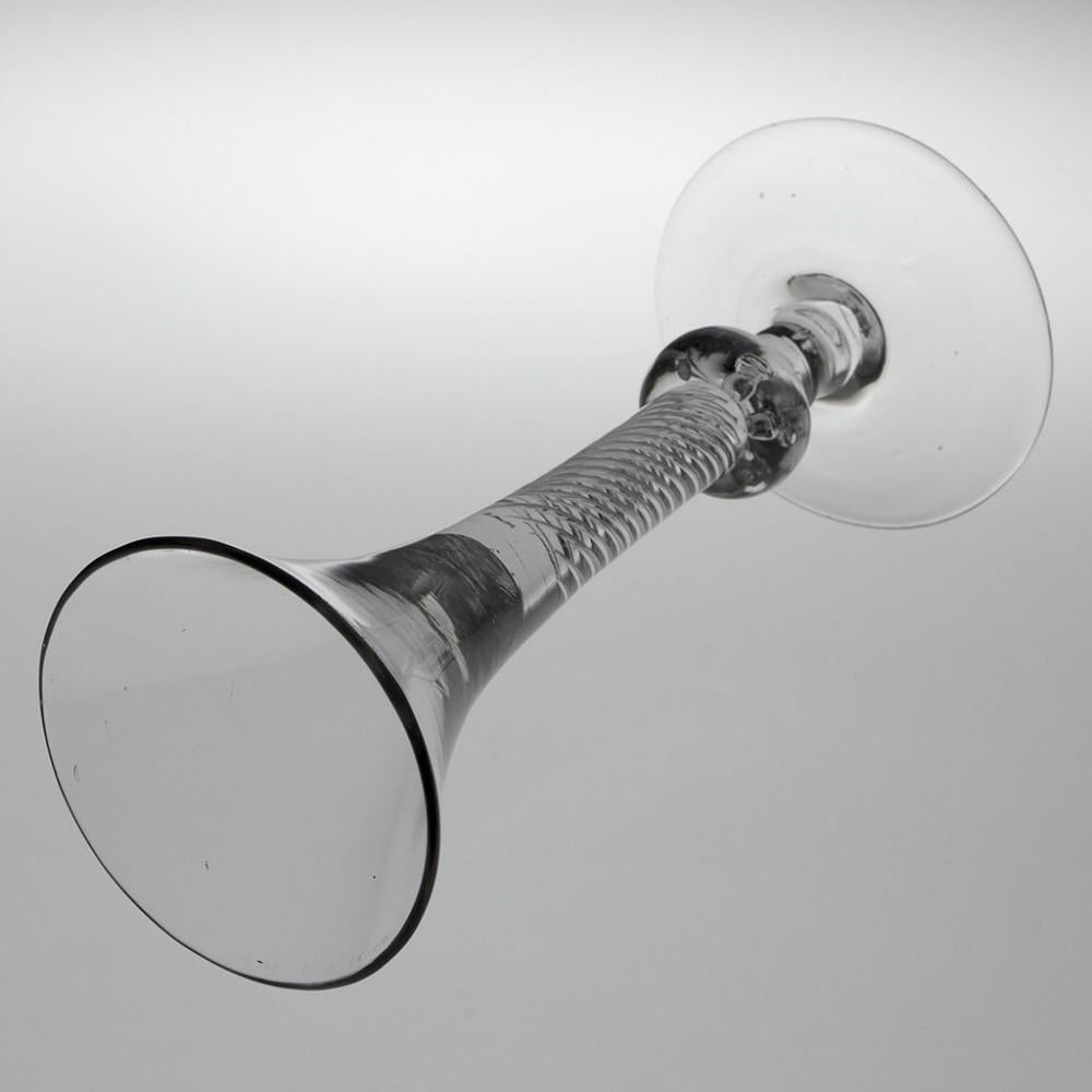 A Very Fine Composite Stem Wine Glass, c1750

Additional information:
Period : George II
Origin : England
Colour : Clear excellent grey hue
Bowl : Drawn trumpet
Stem :Multi series air twist above an air beaded ball knop and short plain stem