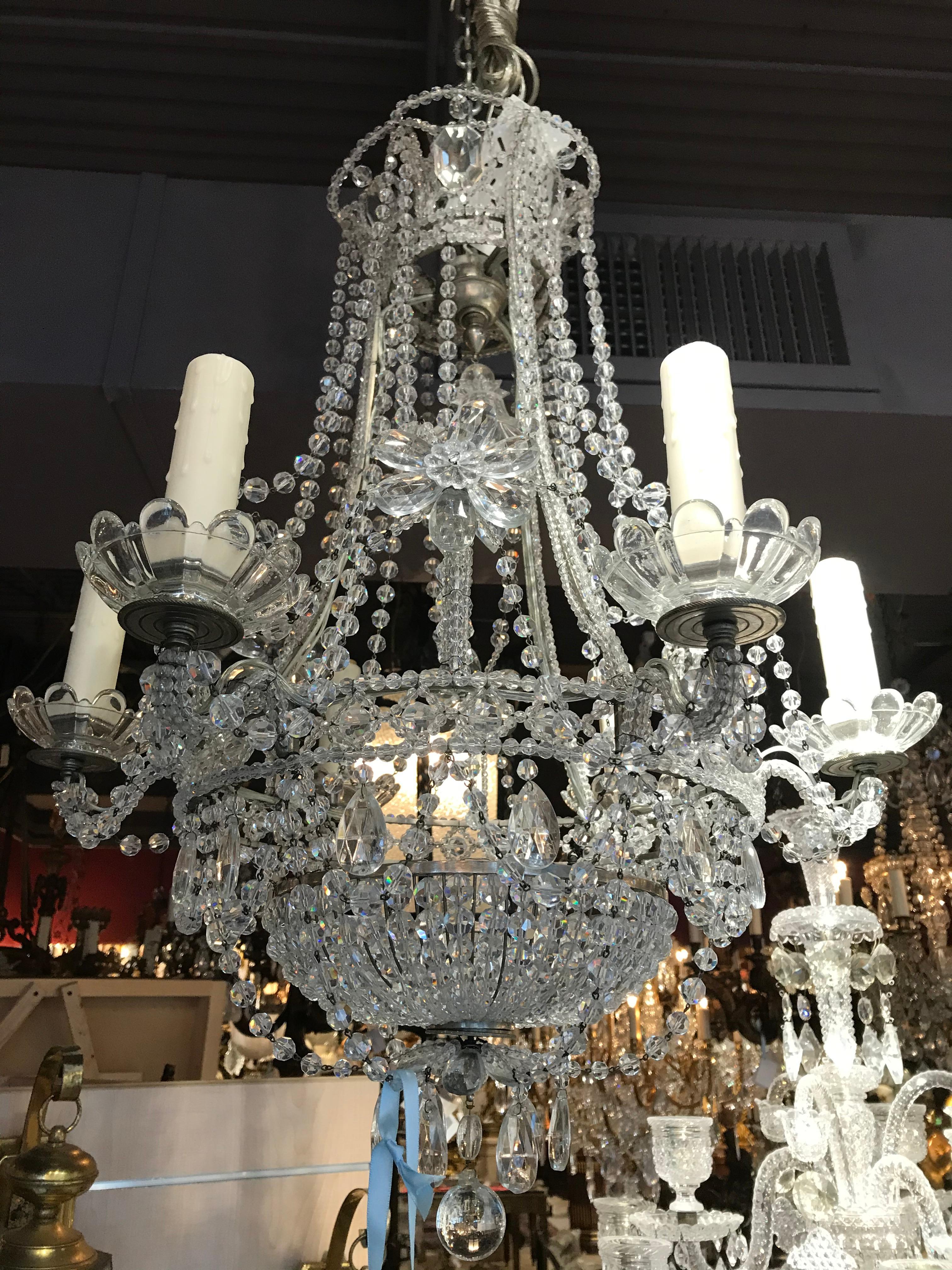 A very fine and decorative silver over bronze and crystal chandelier.
Attributed to Maison Jansen, France, circa 1930.
Dimensions: Height 27