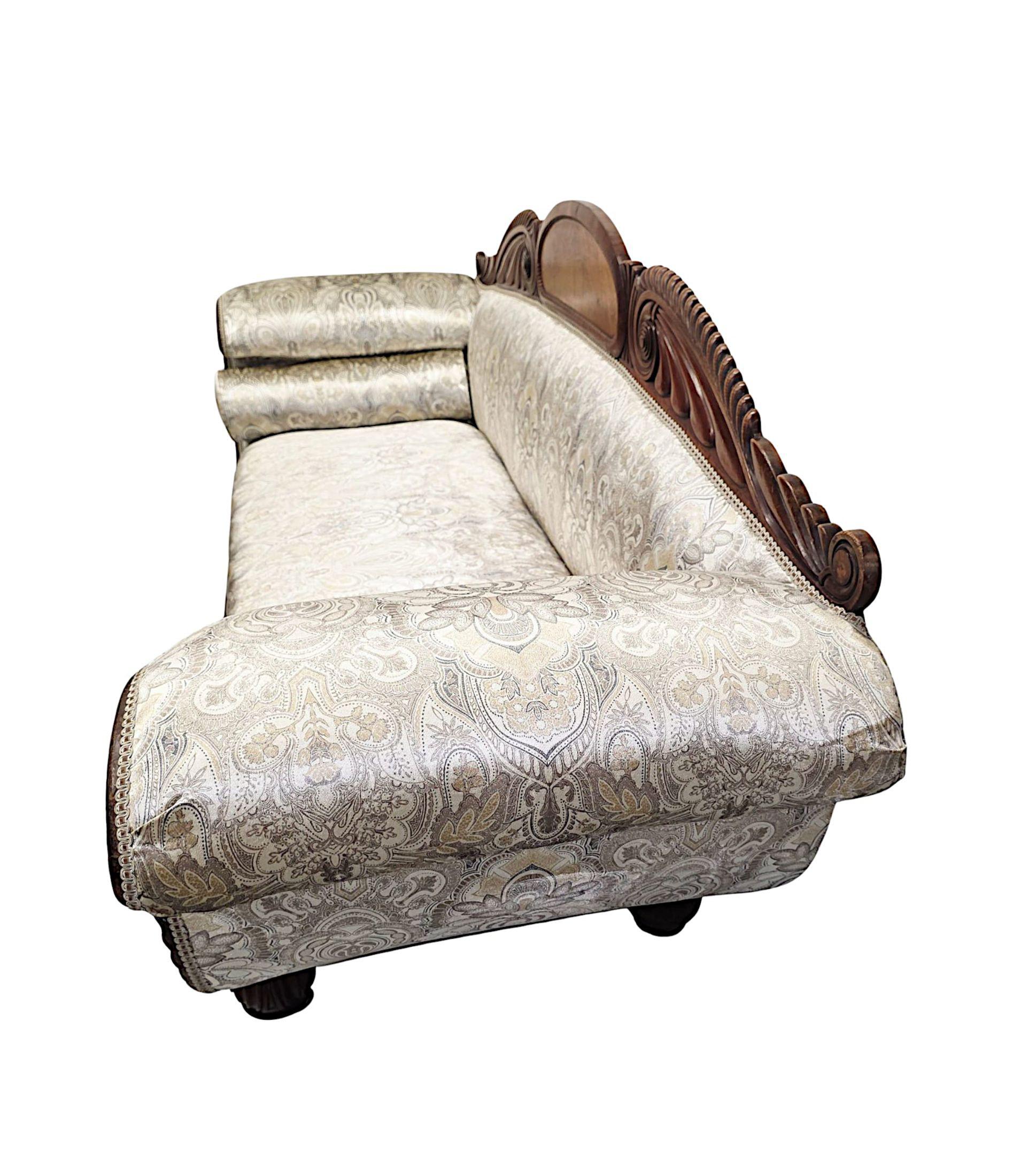 A very fine early 19th Century Irish William IV well figured mahogany framed double ended sofa.  This superb piece is beautifully hand carved with rich patination, grain and is newly re-upholstered in a stunning fabric with fabulous foliate,