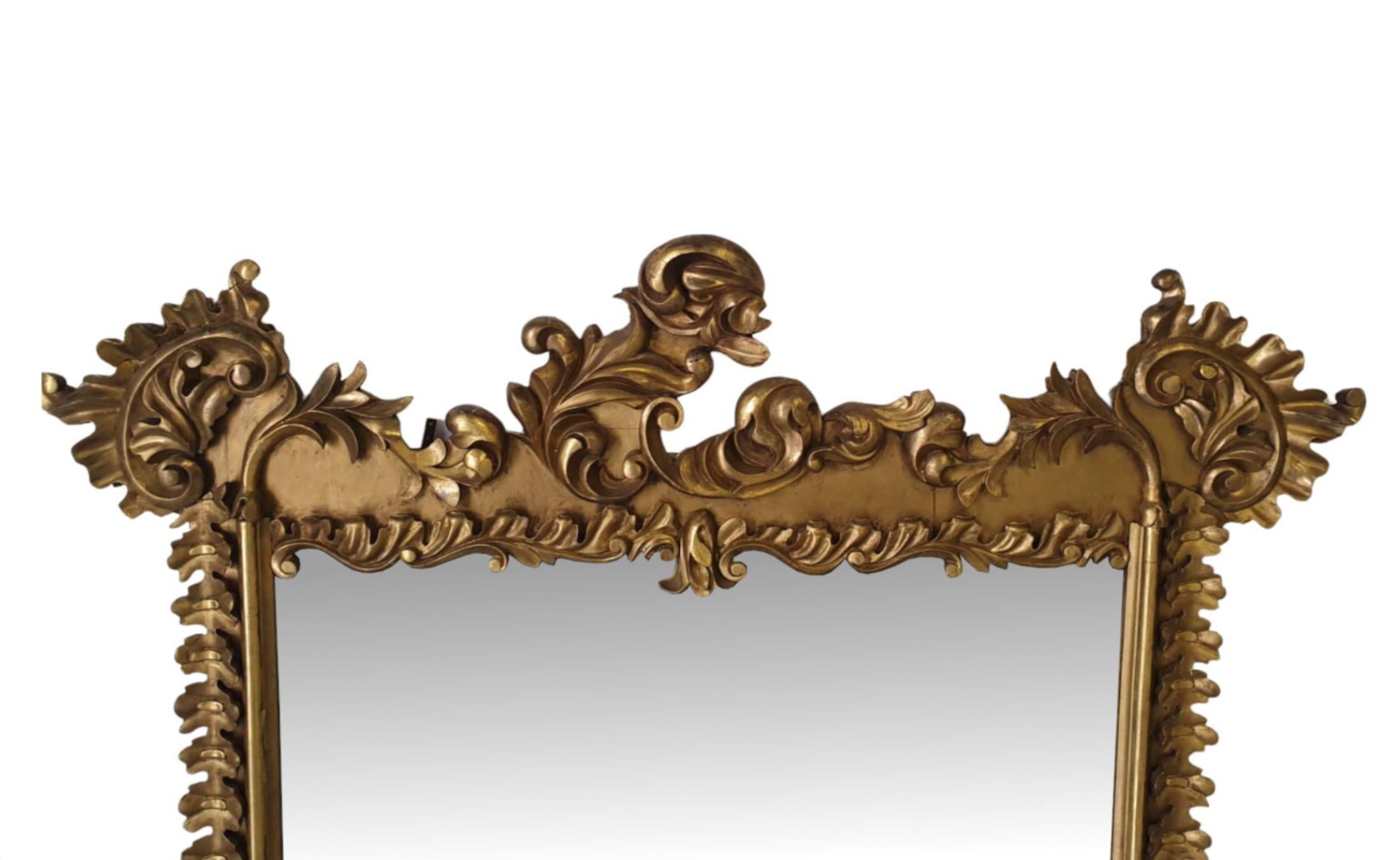 A very fine early 19th century Irish William IV giltwood overmantle mirror. The mirror glass plate of rectangular form is set within an elegantly shaped and moulded giltwood frame, adorned throughout with scrolling foliate, surmounted with stunning