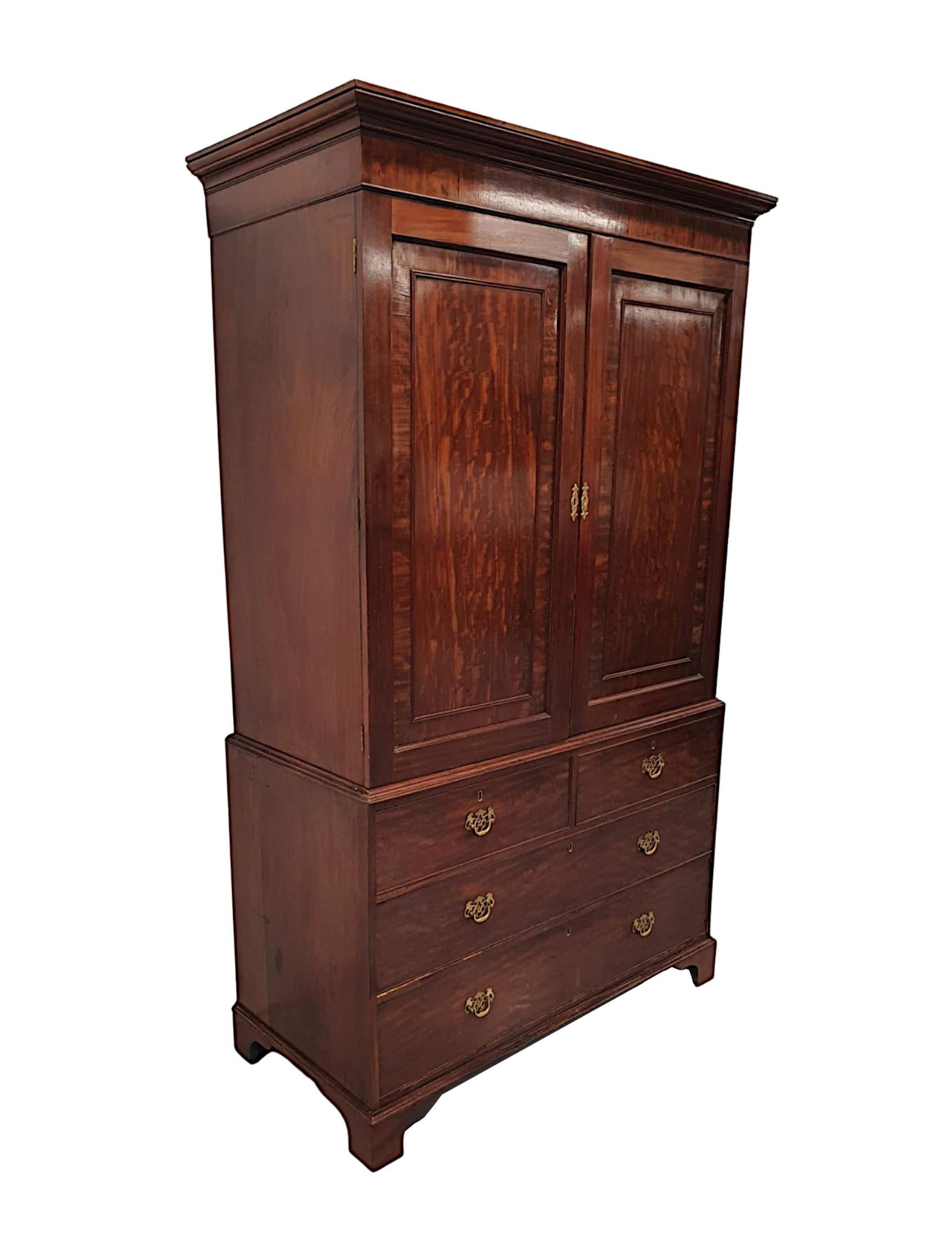 A very fine early 19th century mahogany linen press or wardrobe, of exceptional quality, fabulously hand carved and crossbanded throughout with gorgeously rich patination and grain. The upper section with a stepped and moulded cavetto pediment above
