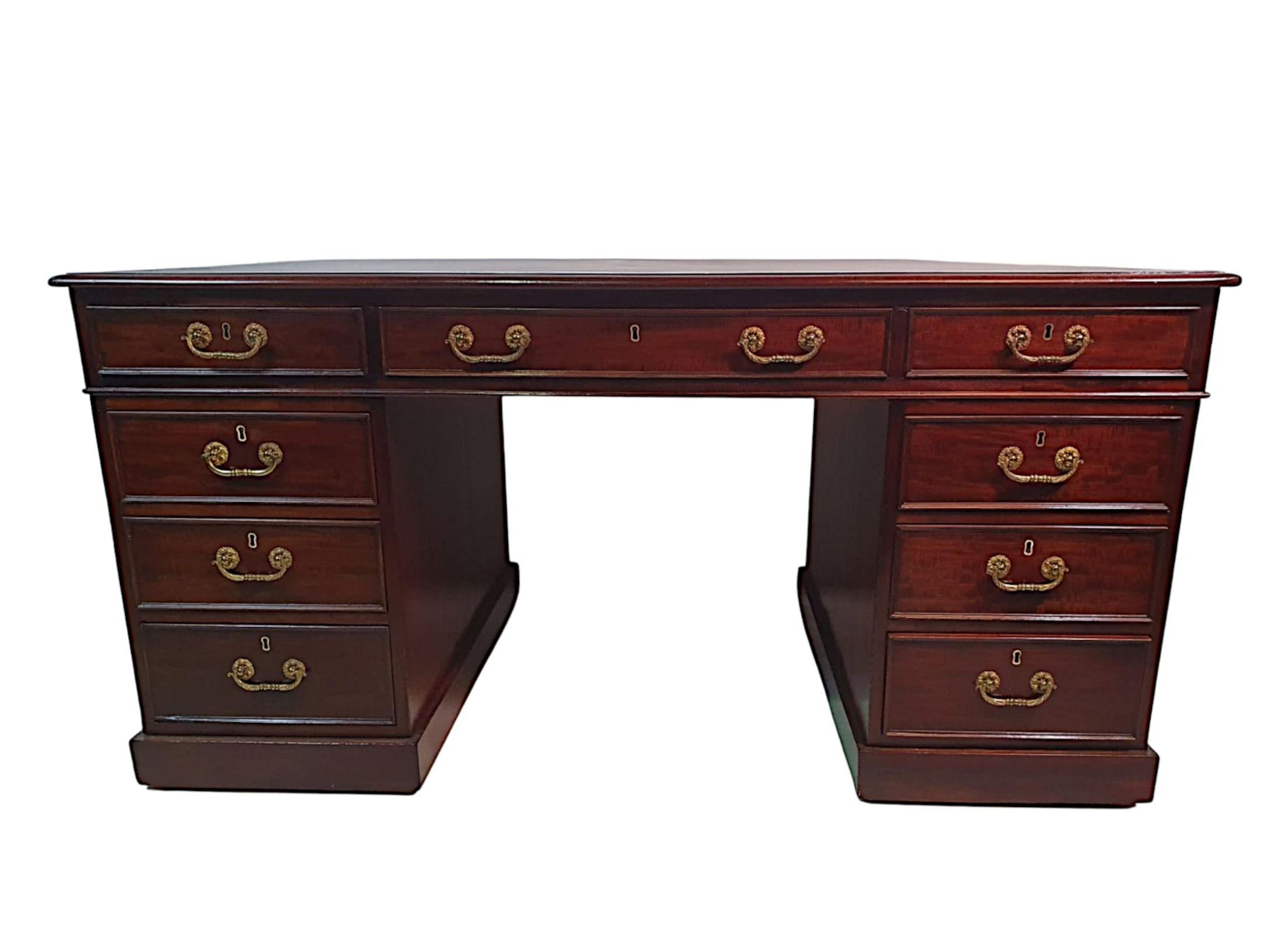 A very fine early 19th Century Regency mahogany partners desk. The moulded top fitted with wine gilt embossed tooled leather writing skiver surface raised over frieze with one long and two short drawers supported on pedestals with three graduated