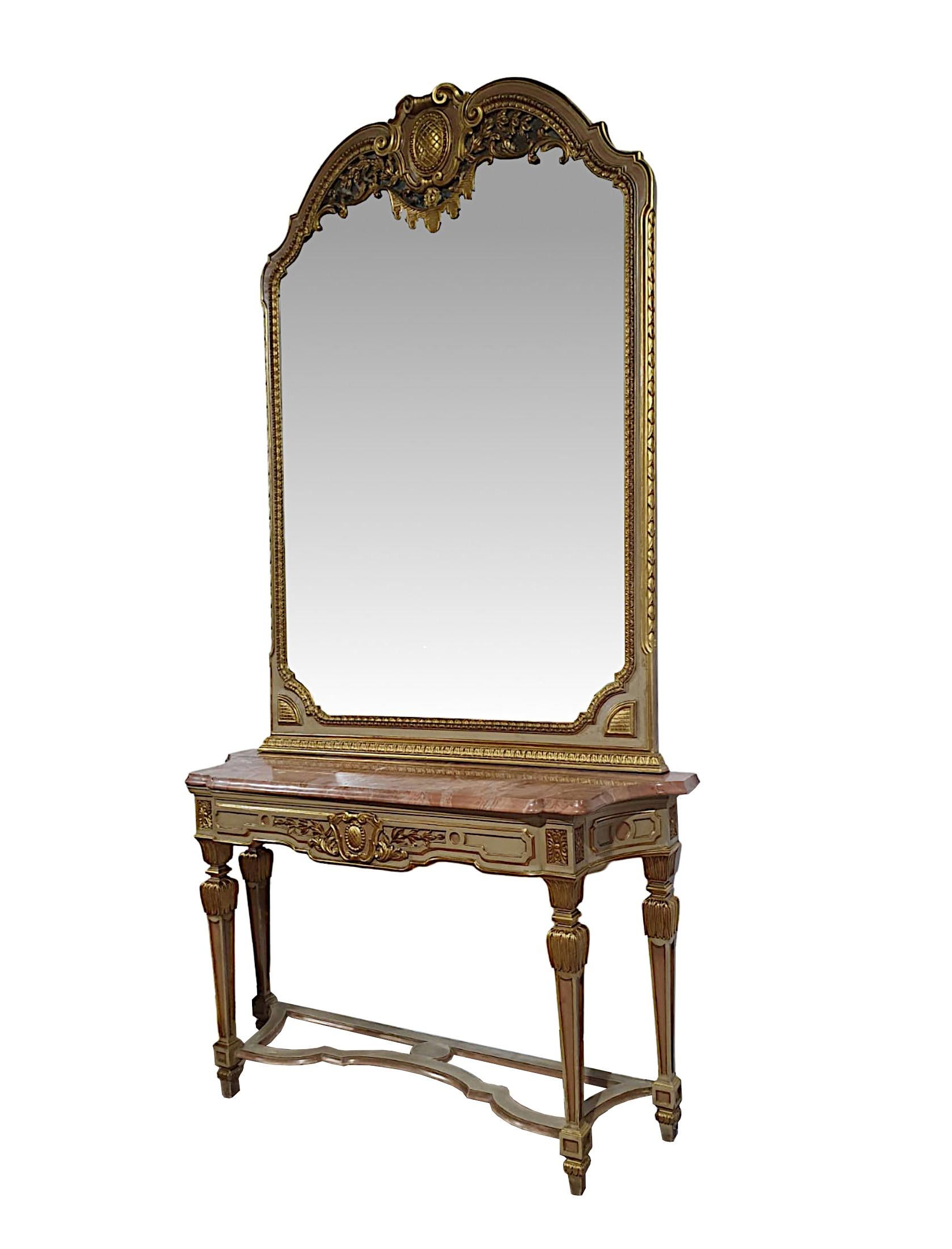 A very fine early 20th century French parcel gilt marble top console table and matching giltwood mirror of exceptional quality. The original sectioned mirror glass plate of arch top form is set within a stunningly hand carved, moulded and pierced