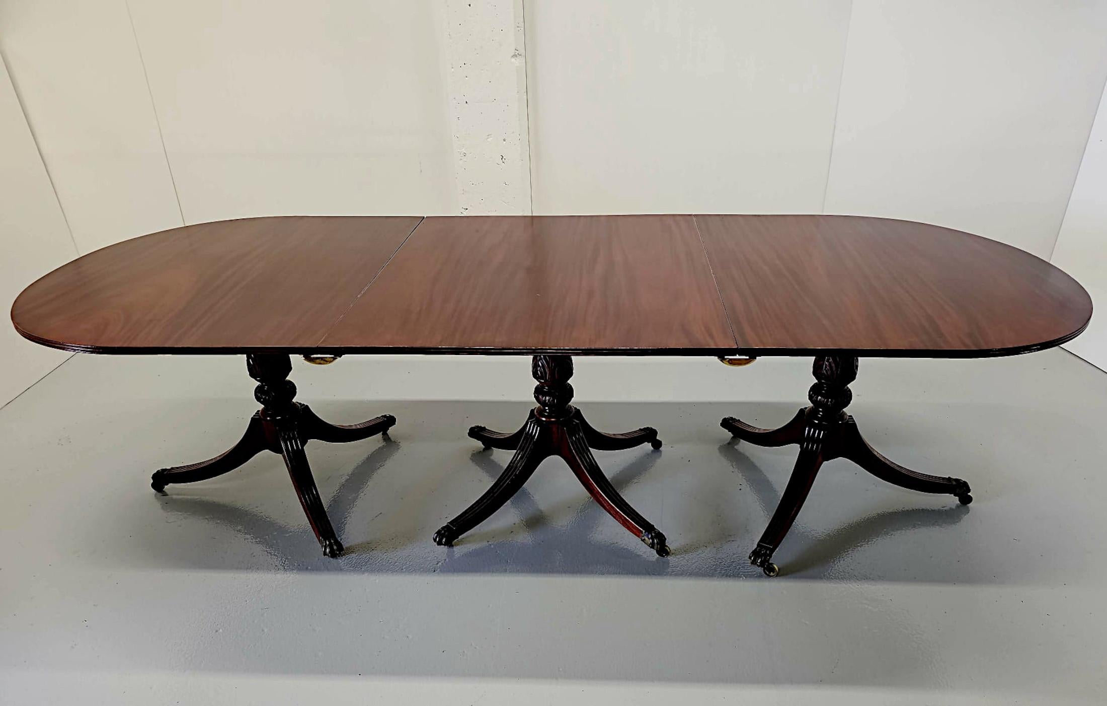 A very fine early 20th Century Regency style D-end dining table, of impressive proportions, fully restored and fabulously carved with beautifully rich patination and grain.  This very fine piece features three interchangeable extension leaves which