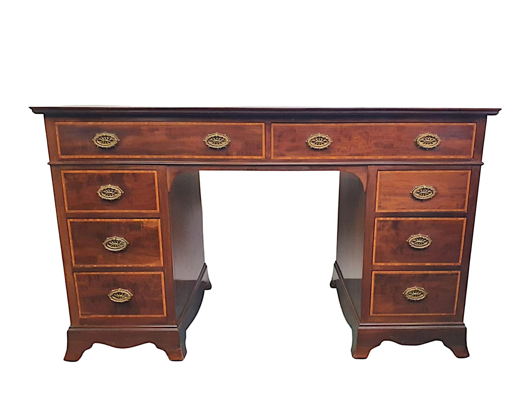 A very fine Edwardian mahogany and satinwood line inlaid pedestal desk, the moulded top inset with gilt embossed red tooled leather writing skiver surface raised over frieze with two long cockbeaded line inlaid drawers with decorative brass ring