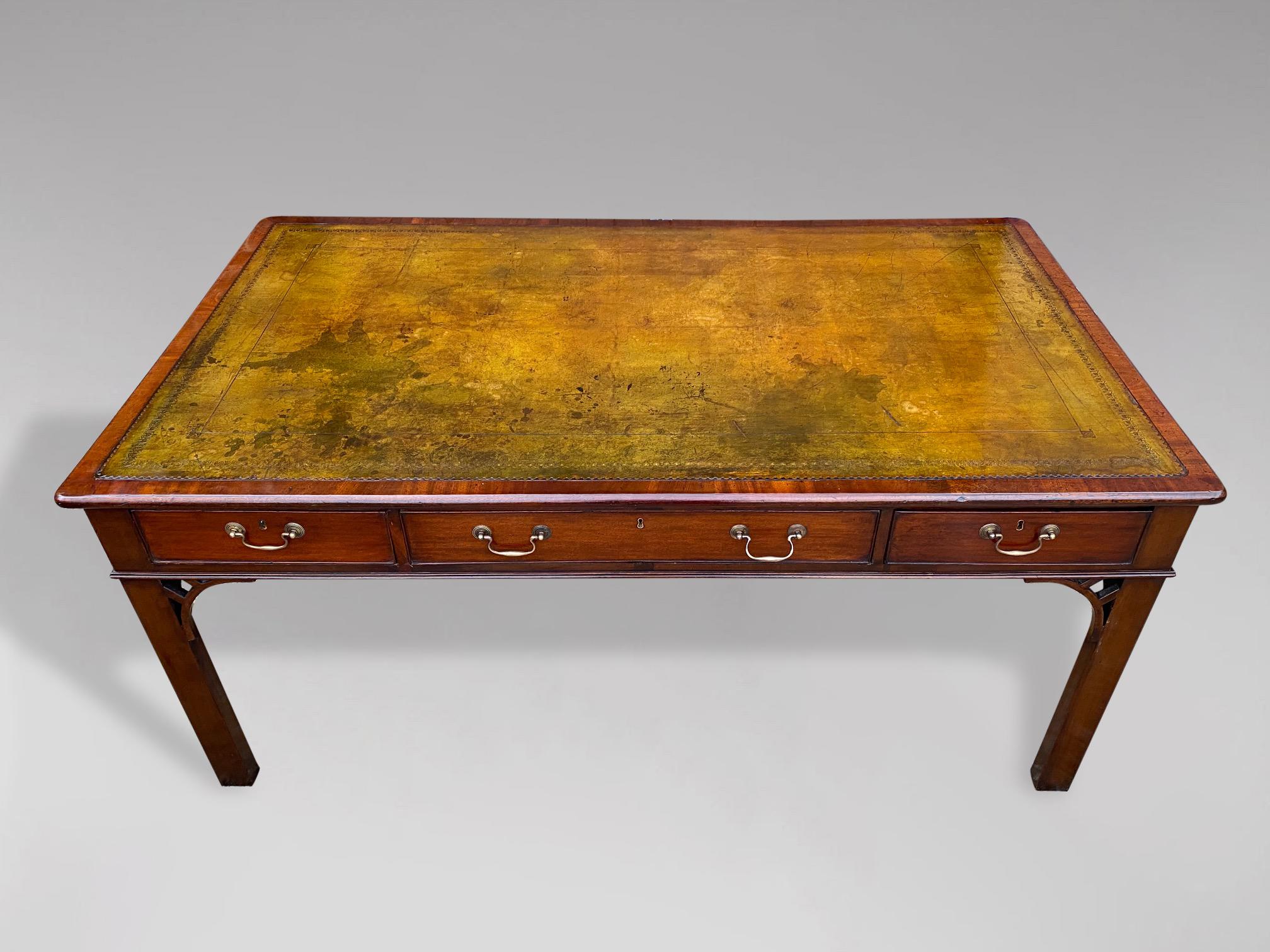 A large fine early 19th century, George III period mahogany partners library writing table. The rounded moulded rectangular top with superb quality light gold green tooled leather inset top above 6 oak lined drawers with the original brass swan neck