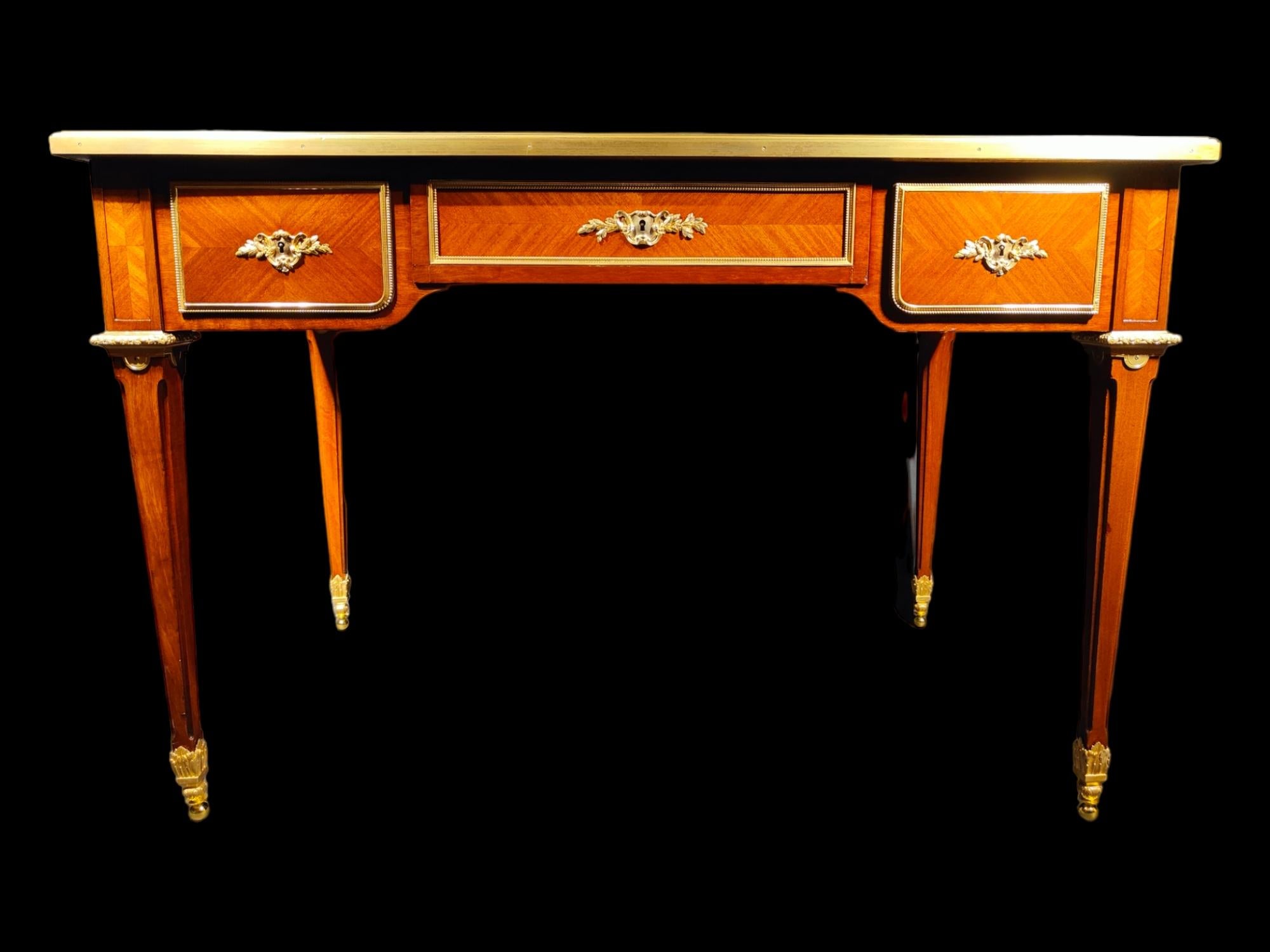 A very fine gilt bronze mounted tulipwood and amaranth desk.
by L. Cueunières (active from 1870).
A french ormolu-mounted mahogany bureau plat.
By l. Cueunieres, third quarter 19th century.
The moulded rectangular top with gilt-tooled yellow