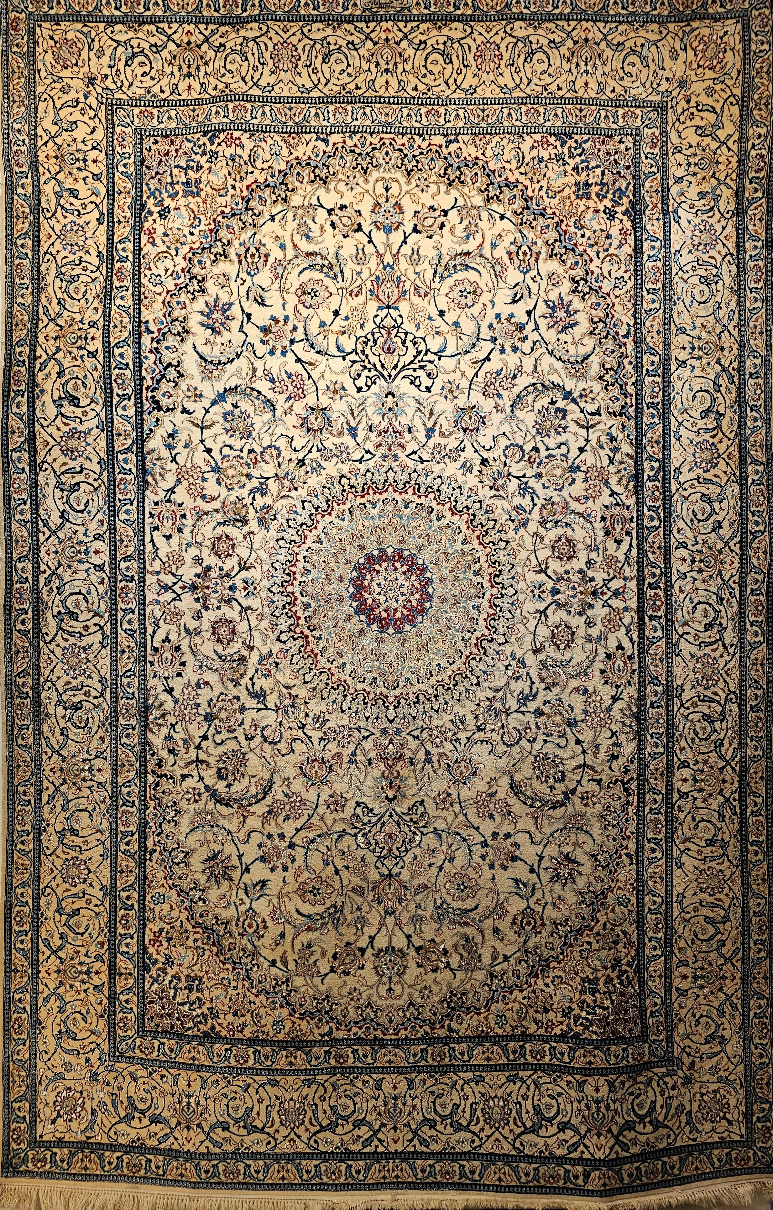 A room size hand-knotted Persian Nain Habibian from the 3rd quarter of the 1900s.  The rug is very finely woven with a wool pile and a cotton foundation and silk highlights that shimmer under light.  The vibrancy of the silk is unbelievable