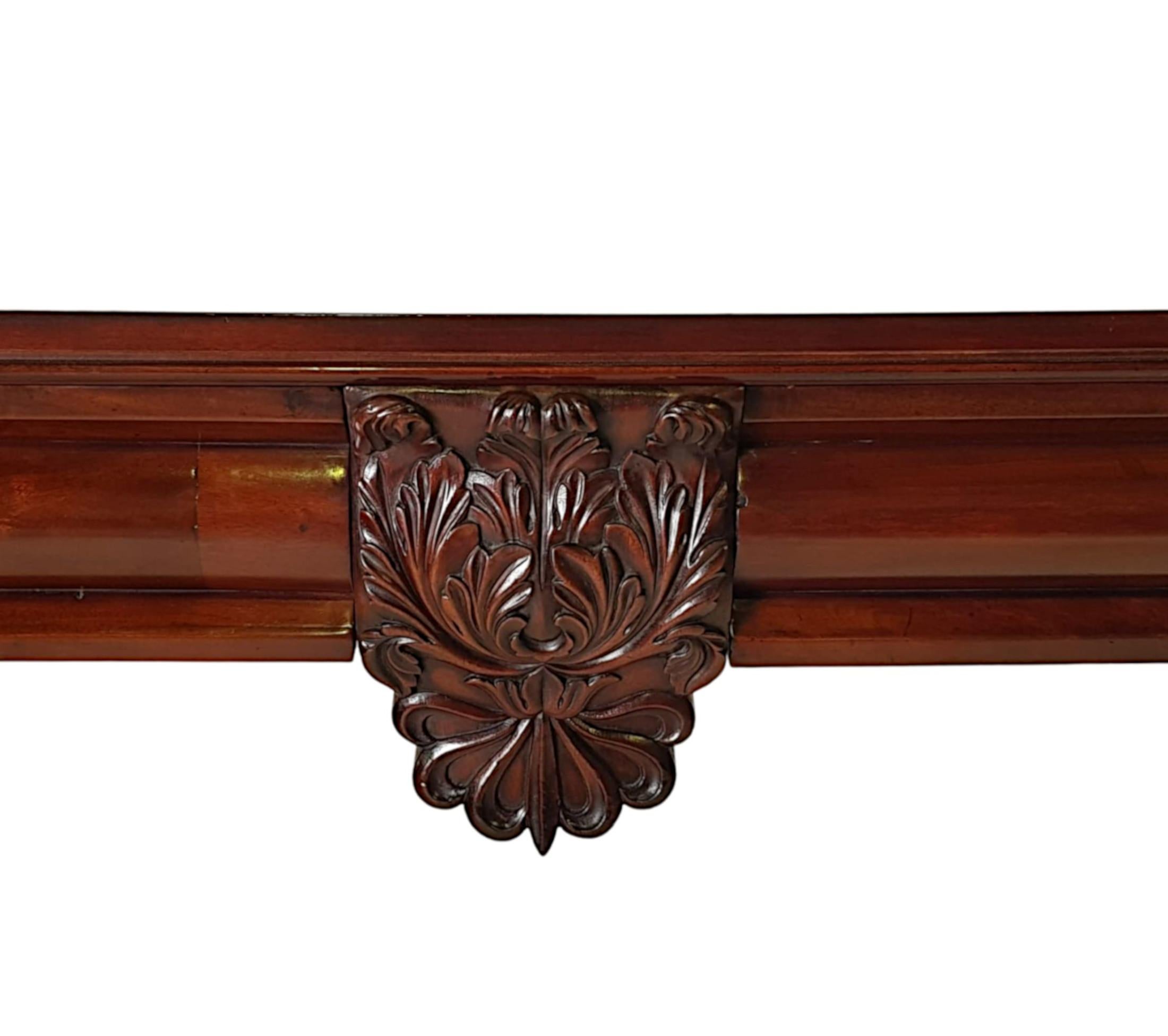 A very fine Irish 19th Century mahogany console or serving table, this exceptional piece is stunningly hand carved with beautifully rich patination, fine grain and profusely decorated with incredibly detailed hand carved motifs throughout.  The well