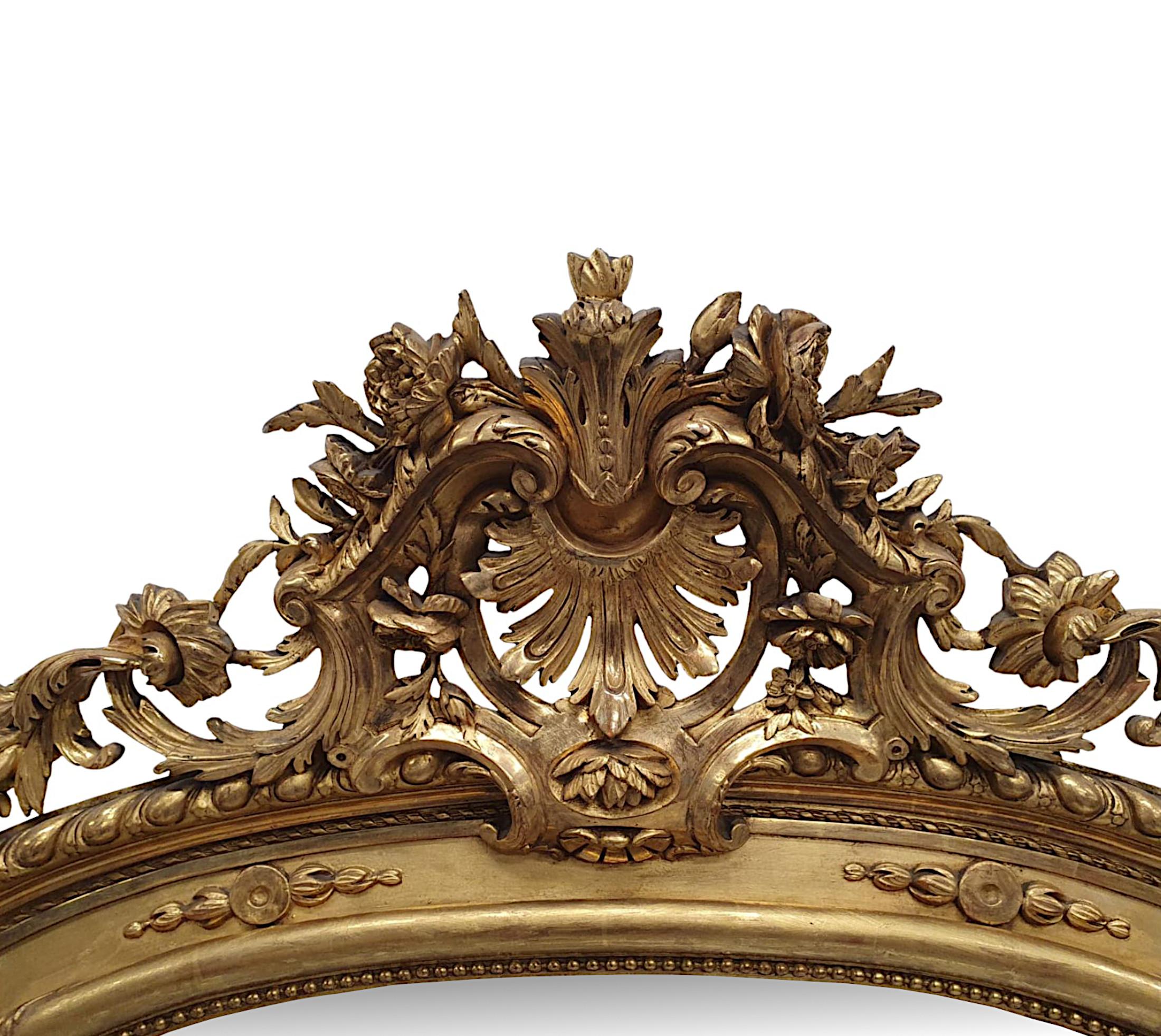 A very fine 19th Century giltwood overmantel or hall mirror of grand  proportions and exceptional quality.  The shaped mirror glass plate is set within a finely hand carved, fluted, moulded and gadrooned giltwood frame with gorgeous beaded row,