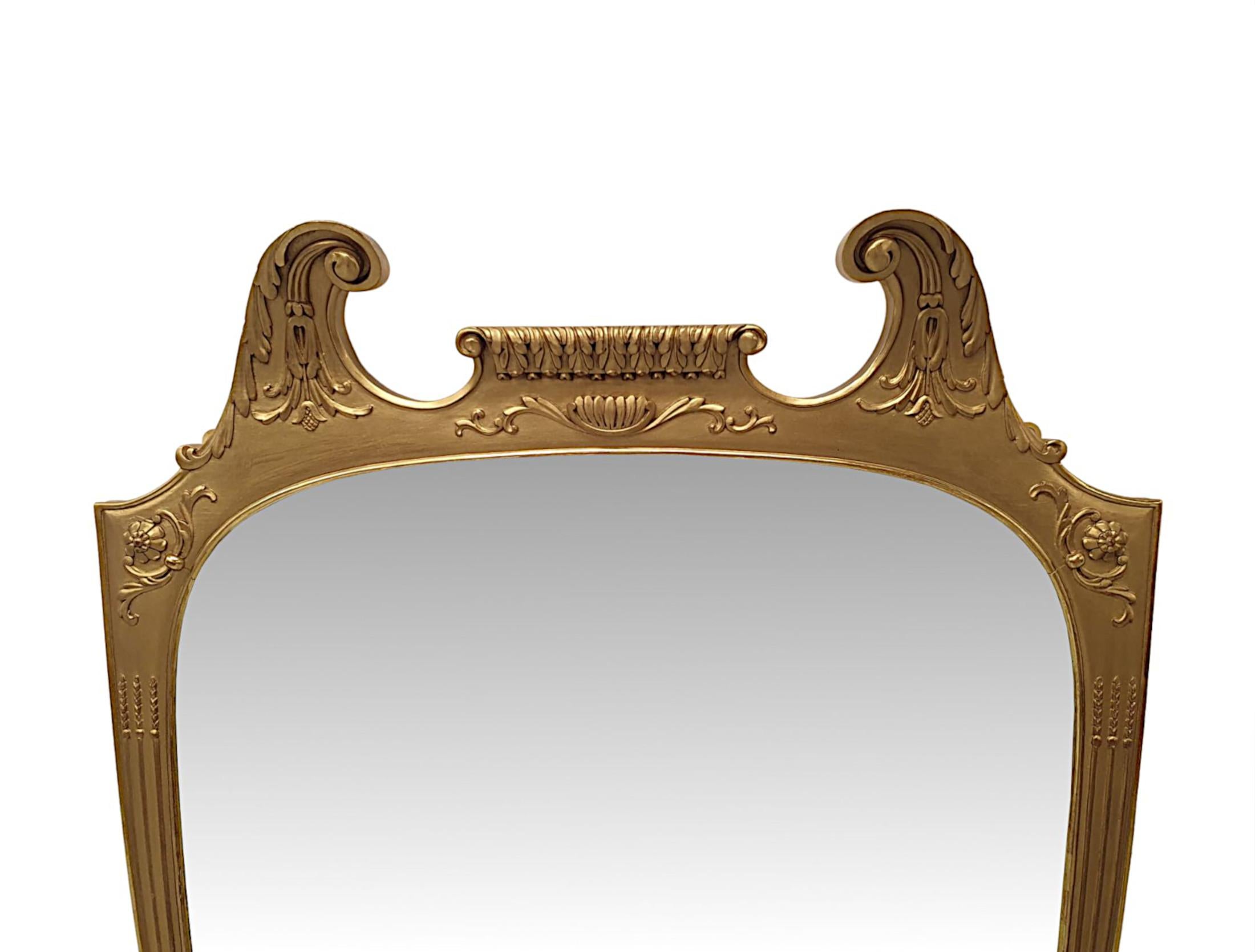 A very fine 19th Century giltwood overmantle or hall mirror. The mirror glass plate of oval form set within a stunning hand carved, moulded giltwood frame with foliate and reeded border detail and with flowerhead and scrolling foliate motif detail