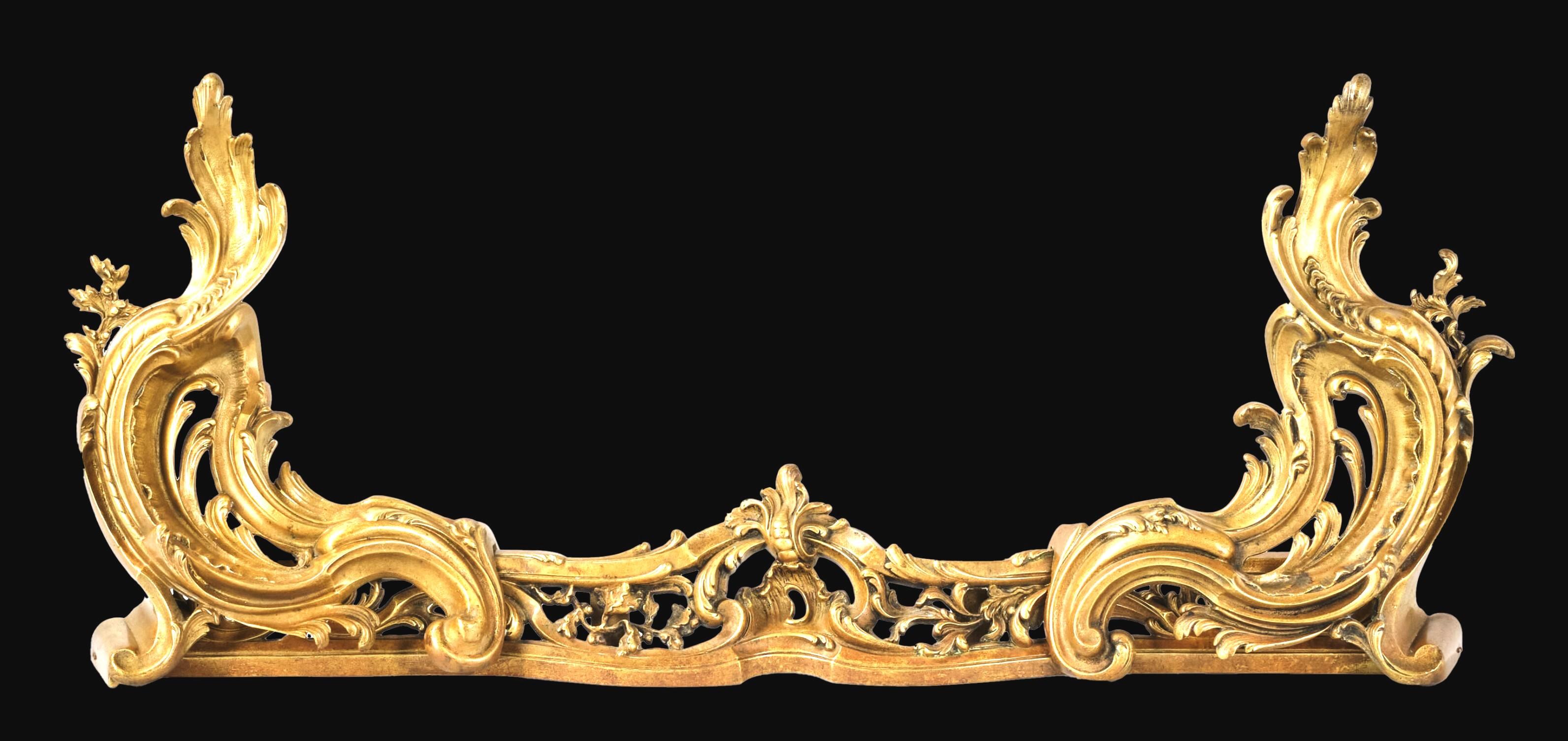 A finely cast & richly gilded 'Belle Epoque' Louis XV style gilt bronze fire fender together with its matching pair of robust gilt bronze chenets. 
Both pierced & foliate cast chenets feature the ability to extend the length of the fender thereby