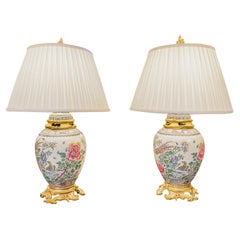 A very fine pair of 19th c French Famille Rose porcelain and gilt bronze lamps A very fine pair of 19th c French Famille Rose porcelain and gilt bronze lamps