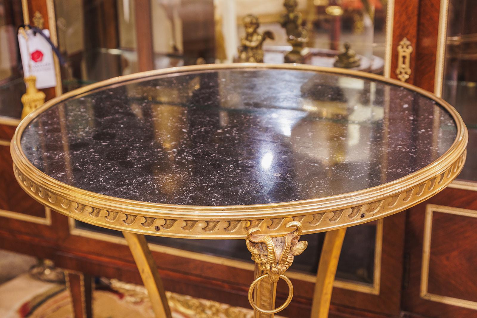 A fine pair of late 19th century French Louis XVI gilt bronze and marble top gueridon tables. Fine details and gilding . Original Belgium black marble tops 