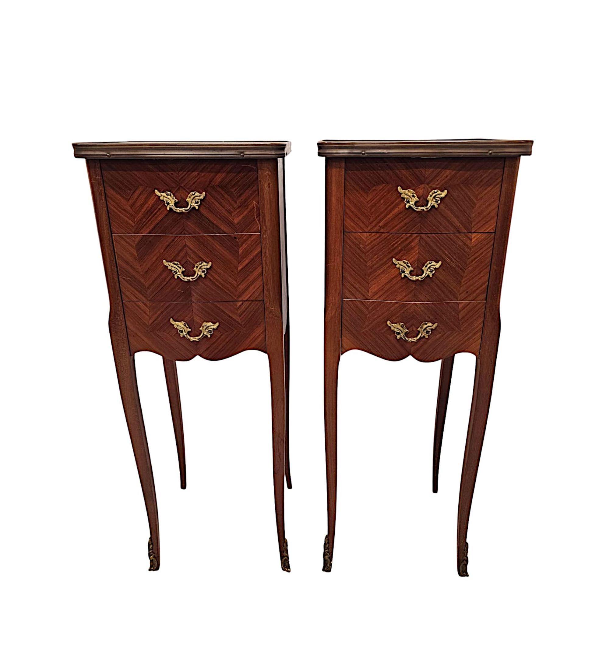 A very fine pair of  20th Century richly patinated and well figured mahogany and kingwood marble top bedside chests or tables of exceptional quality, neat proportions and ormolu mounted throughout.  This stunning pair are finely carved and quarter