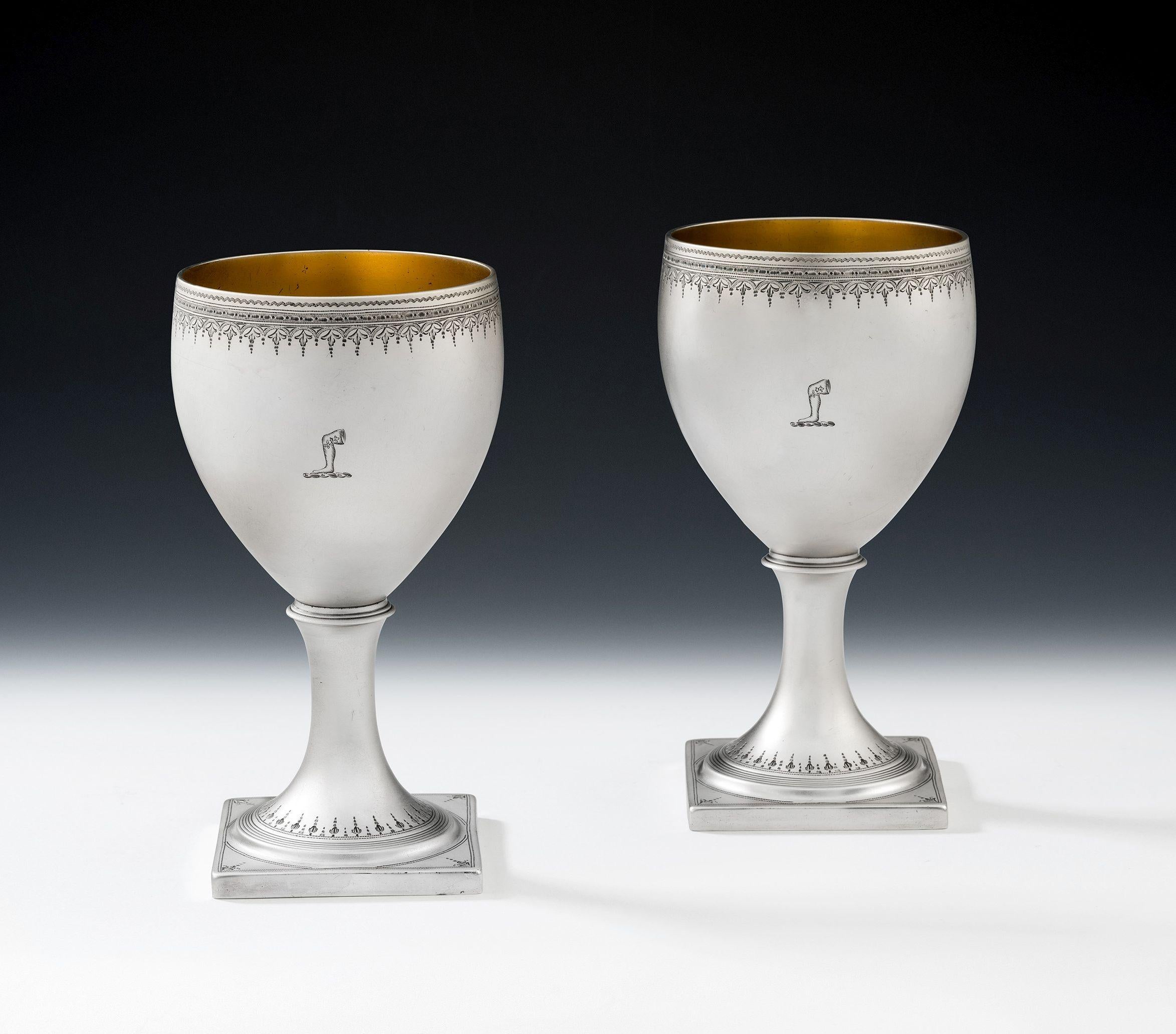 These exceptional Wine Goblets stand on a square pedestal foot decorated with circular reeding and an eclectic mix of bright cut and prick dot designs. The foot rises to a vase shaped bowl, with beautiful rim engraved with bright cut designs,