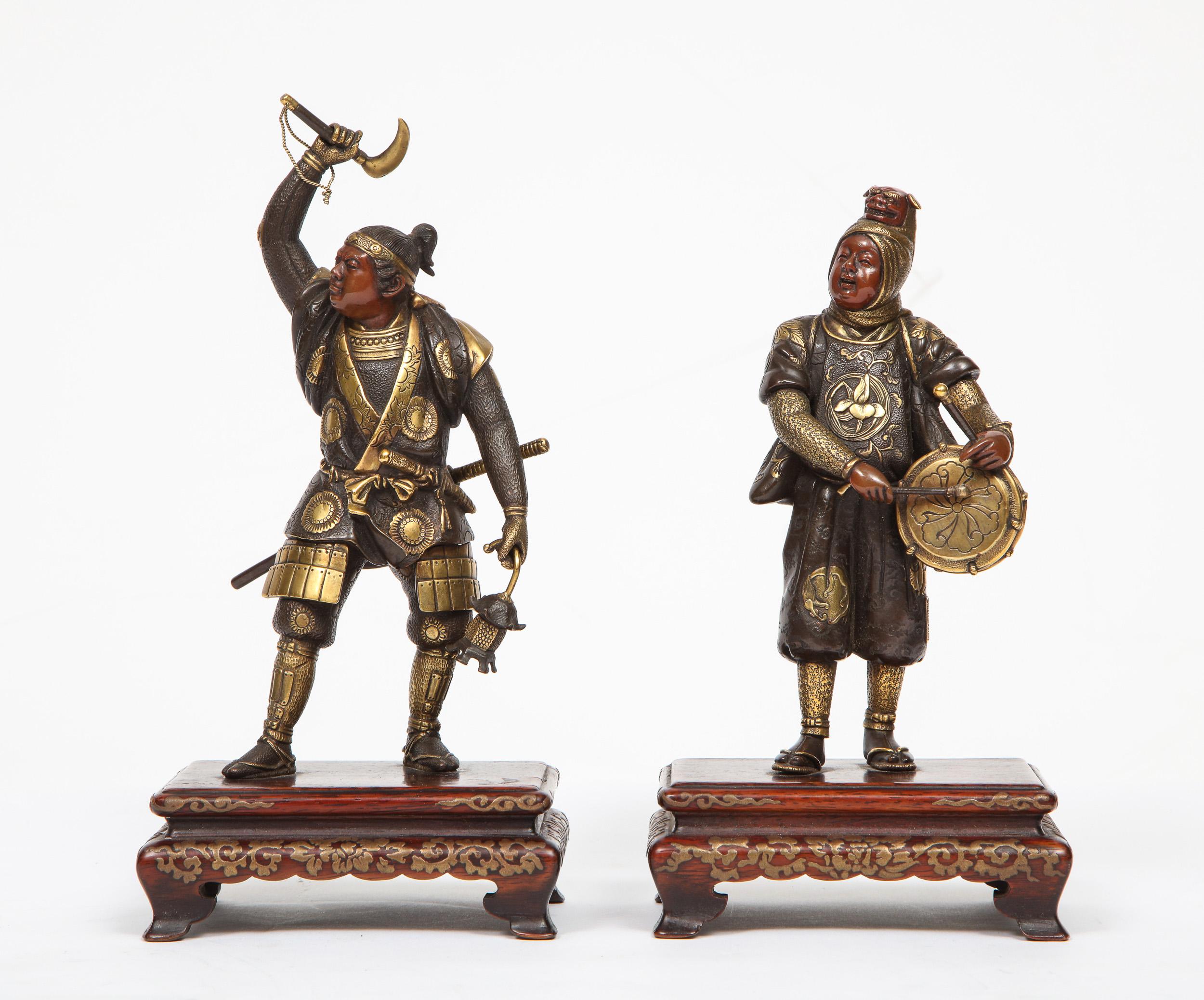 Very fine pair of Japanese bronze figures by Miyao Eisuke, Meiji period (1868-1912).

One standing wearing full armour, the other beating a drum, their coats finely carved with ho-o and dragons, with wood stands decorated with gold lacquer ho-o