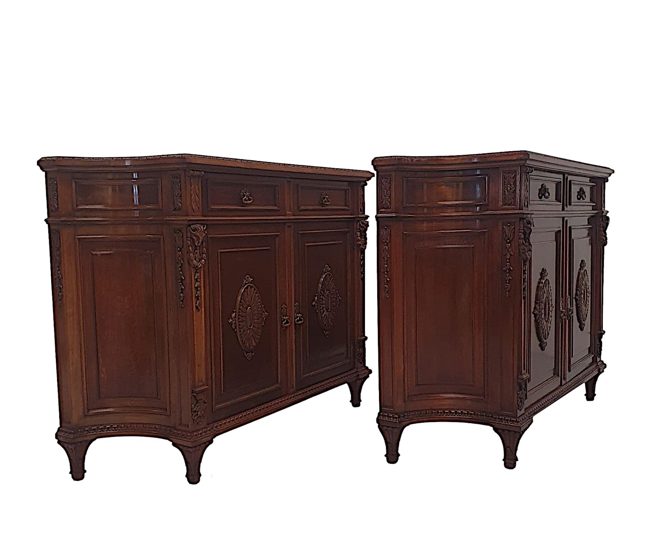 A very fine pair of mid 20th Century mahogany side cabinets, with beautifully carved detail throughout and a deeply rich patina.  The moulded and shaped top with concave sides, framed with egg and dart beaded edge raised over two short drawers with