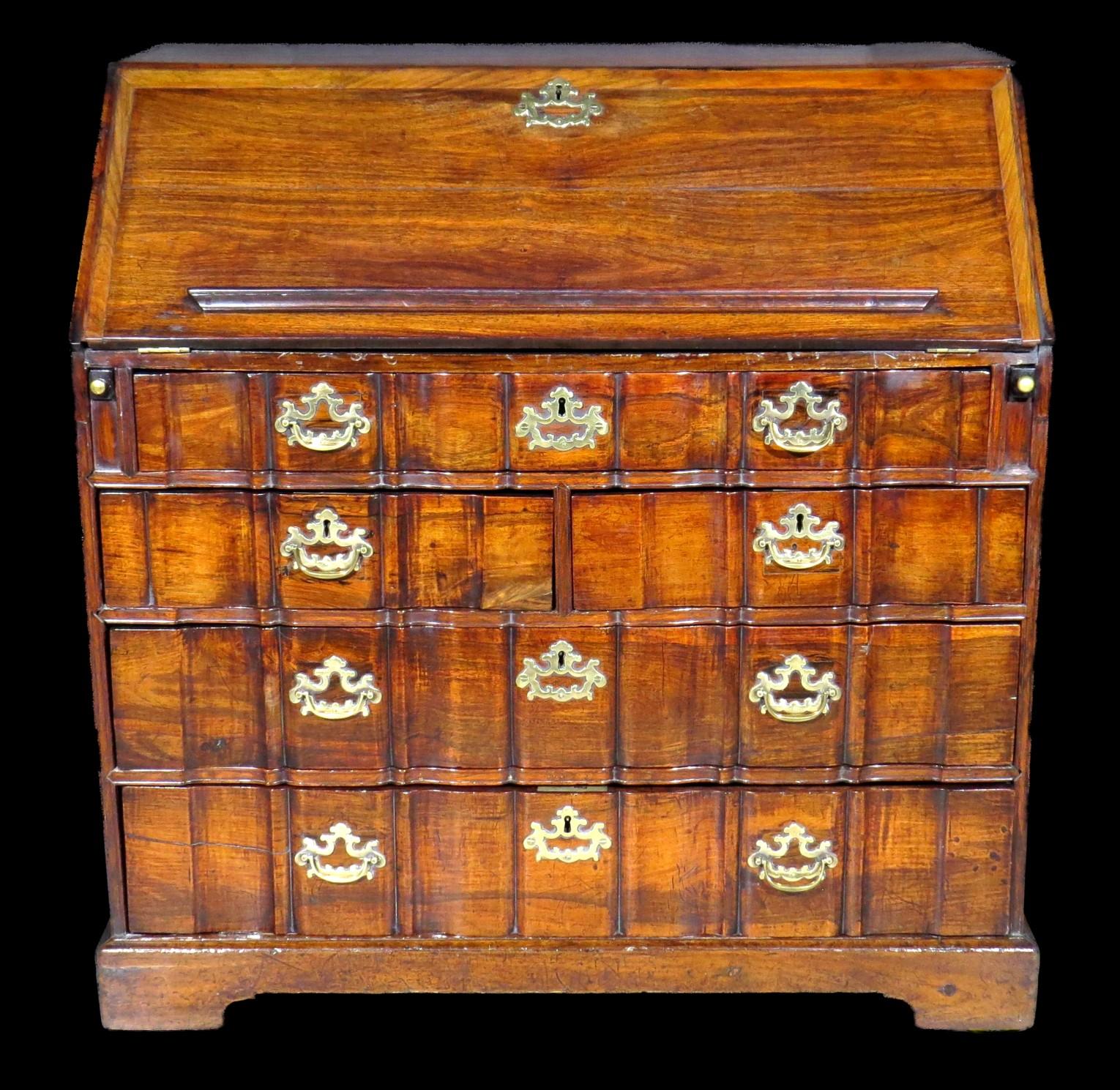 The richly figured case showing a drop-down panel affixed with a lectern bar, opening to an interior fitted with an arrangement of banks of small drawers, pigeonhole compartments & vertical compartments with fluted fronts, centred by a small
