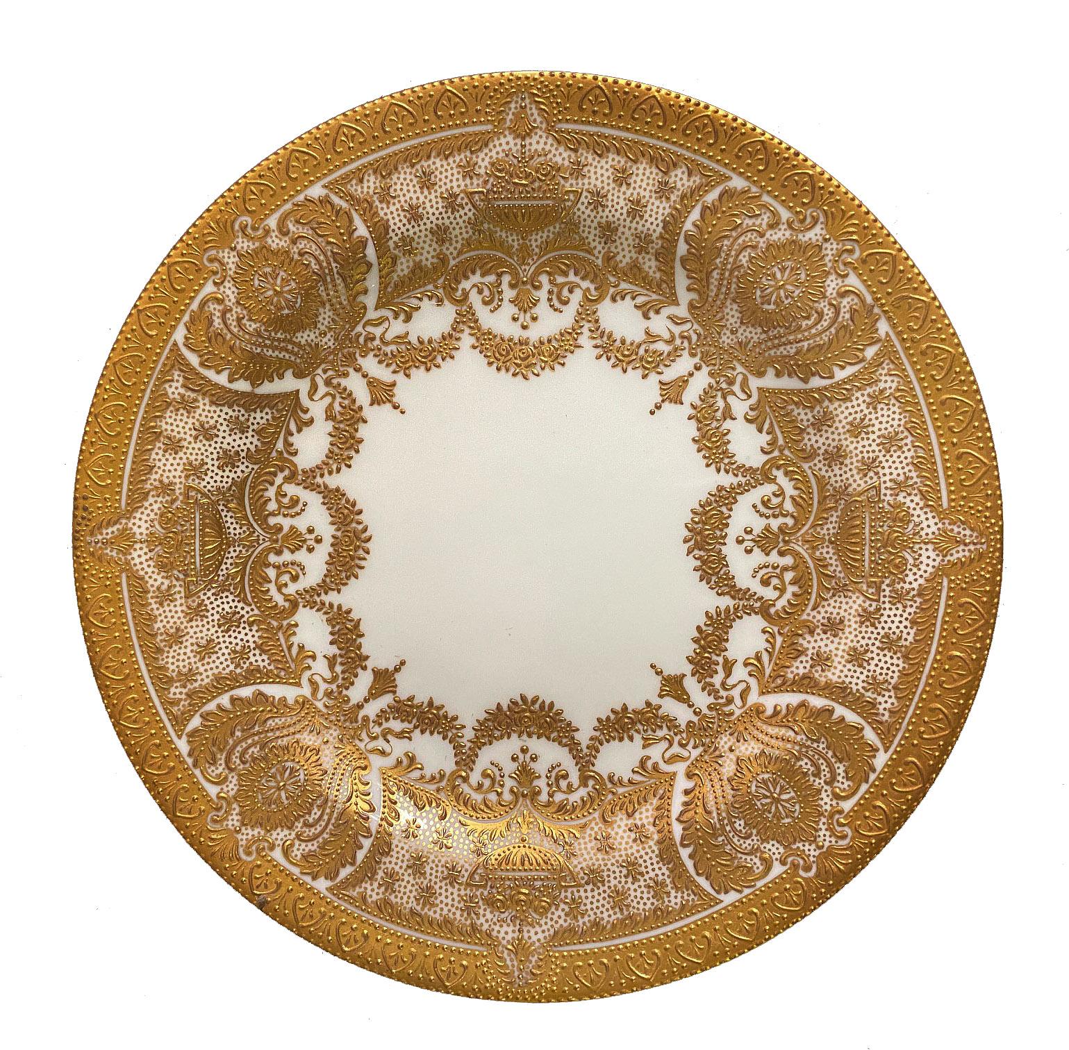 A very fine set of fourteen early 20th century English Cauldon bread plates.

Finely decorated with raised gold.

Stamped Cauldon China England on the back of the plates.
