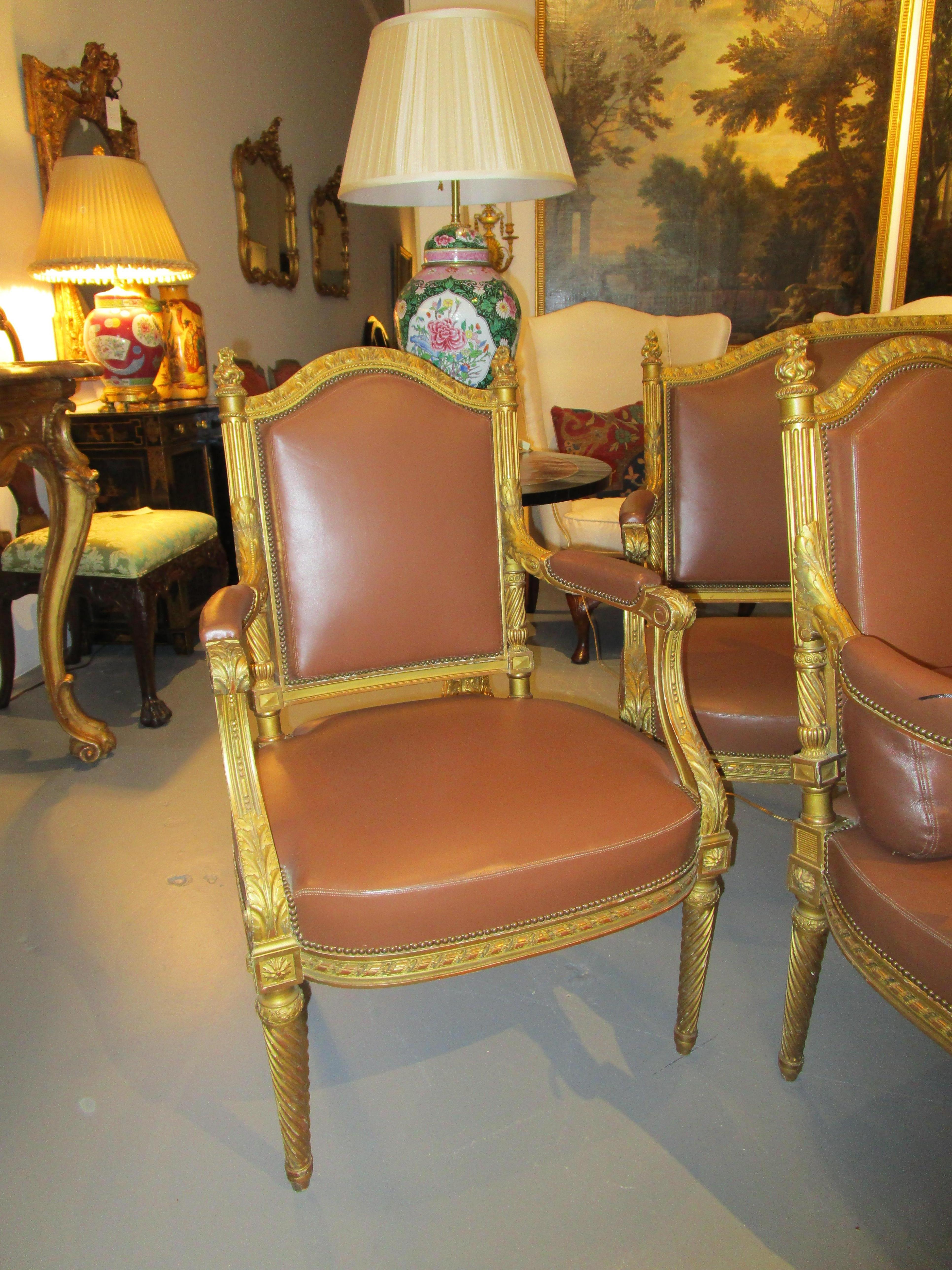 A very fine suite of 19th century French Louis XVI armchairs and settee. Finely carved and detailed with the original gilt and covered in a Hermes leather The armchairs. Measure: 38''H.