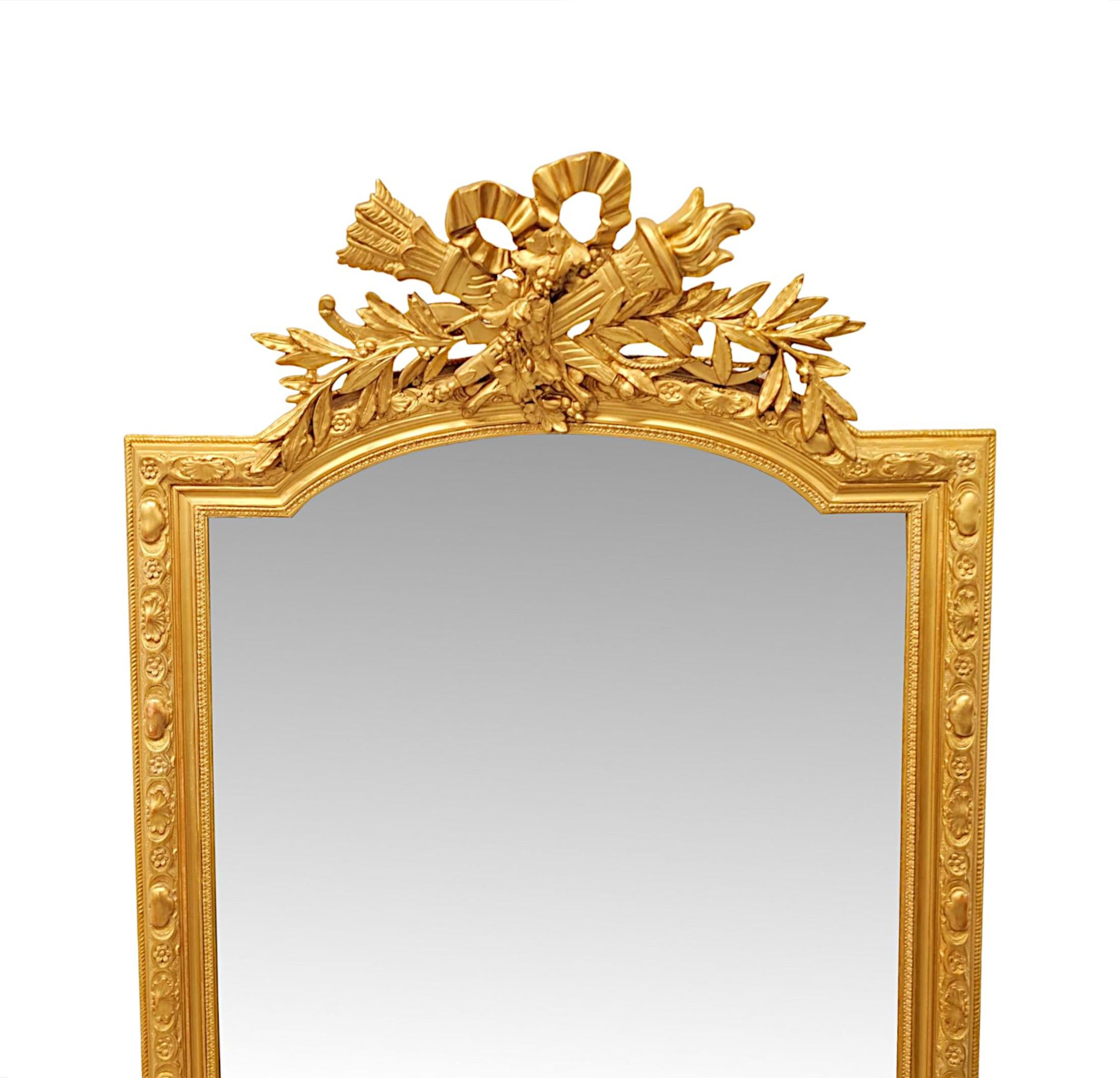 A very 19th Century giltwood pier or dressing mirror of tall proportions and exceptional quality.  The shaped, bevelled mirror glass plate is set within a stunningly hand carved, moulded and fluted giltwood frame with gorgeous flowerhead, stylised