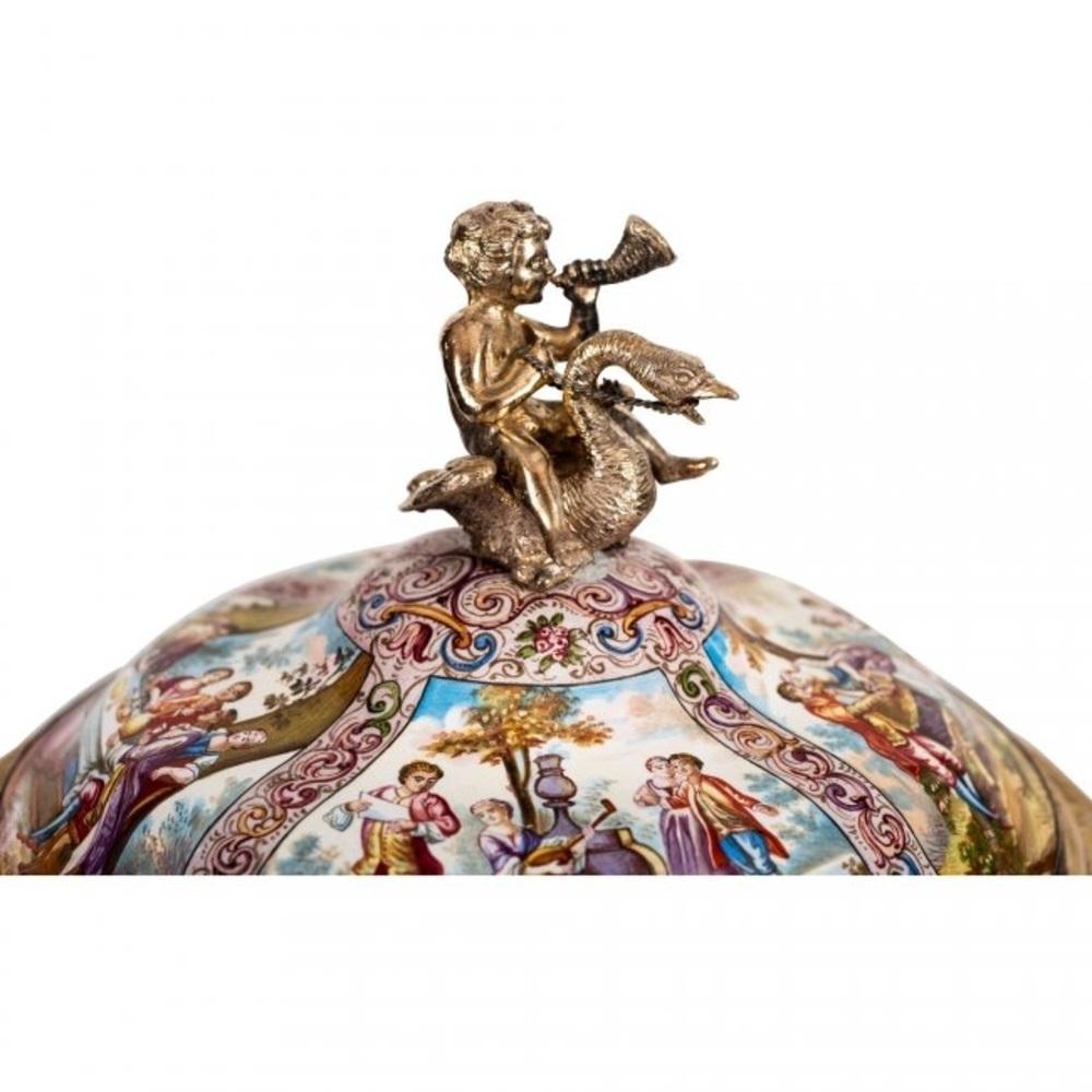 A very fine Viennese silver-gilt-mounted enameled cup and cover,
by Karl Rossler,
Last quarter of the 19th century.
The spreading detachable cover surmounted by a putto riding a swan, decorated allover with reserves depicting 18th century scenes,