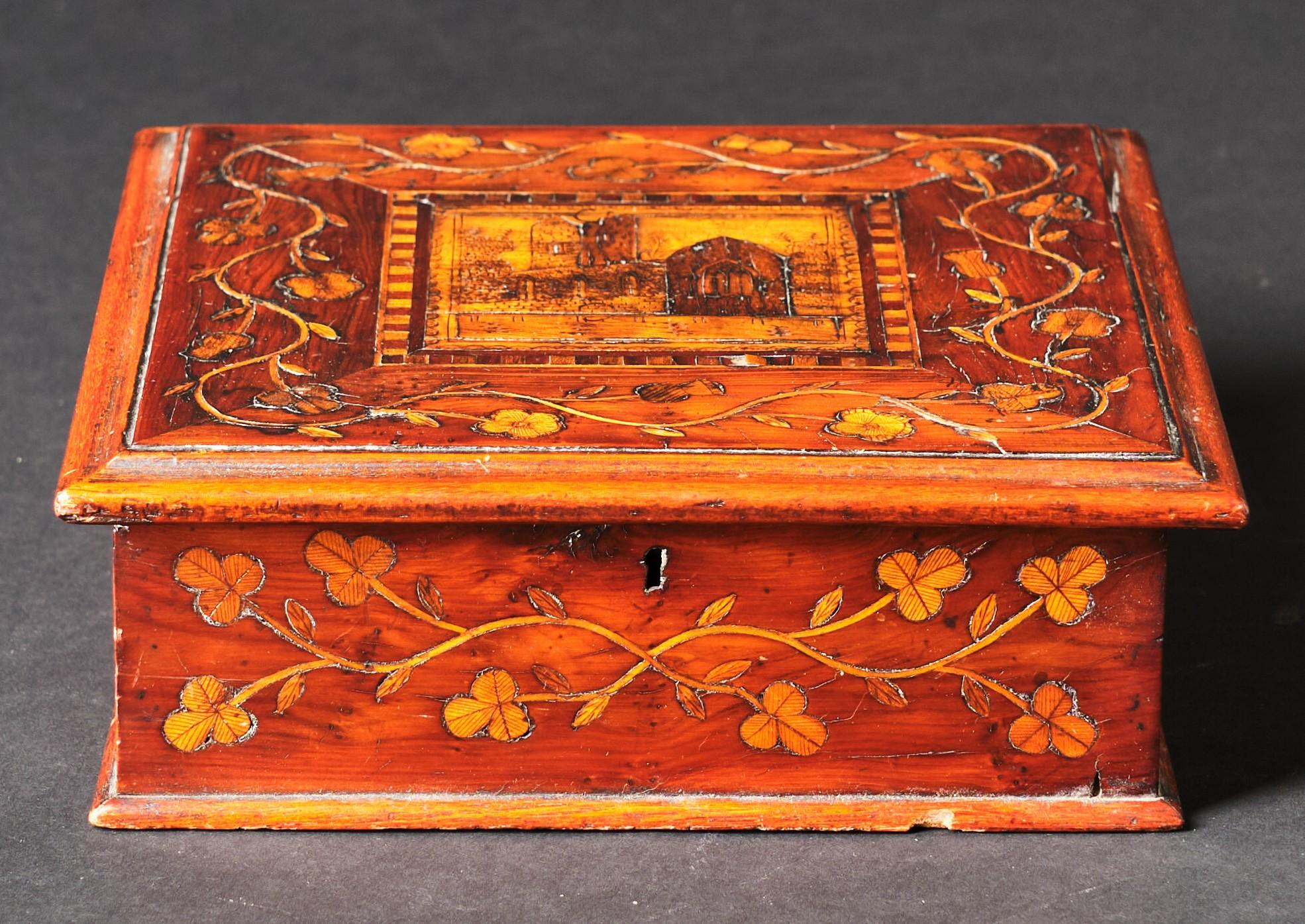 A very handsome 19th century dresser box hand constructed in Arbutus wood. The hinged lid featuring an intricately inlaid marquetry panel depicting Muckross Abbey surrounded by inlaid motifs of meandering vines, thistles & shamrocks. The interior