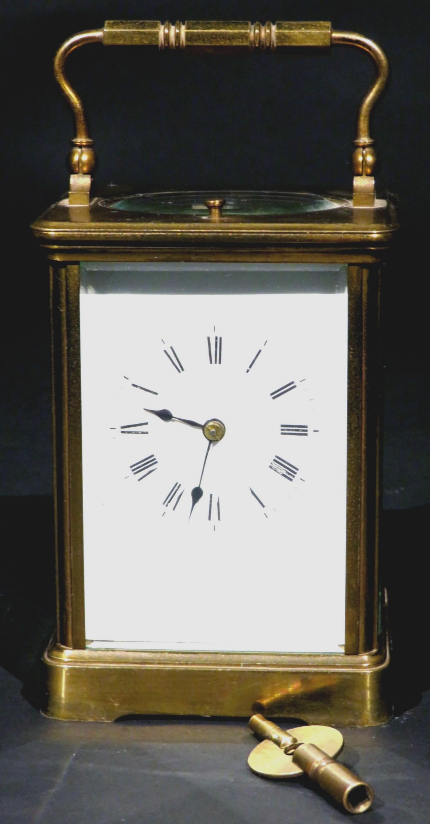 A very handsome 19th century repeating carriage clock having a glass paneled brass case, fronted by a white enamel clock face with Roman numerals & blued steel hands, the 8 day movement striking on the full and half hour, stamped on the reverse EGL