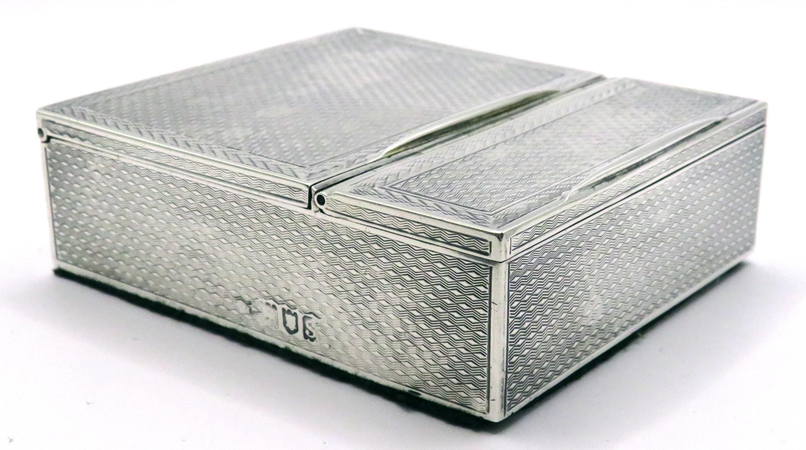 A very handsome & substantial early 20th century Art Deco sterling silver stamp box. The case richly decorated overall with striking basket-weave & herringbone machined motifs, the top fitted with two lidded compartments with gilded interiors, the