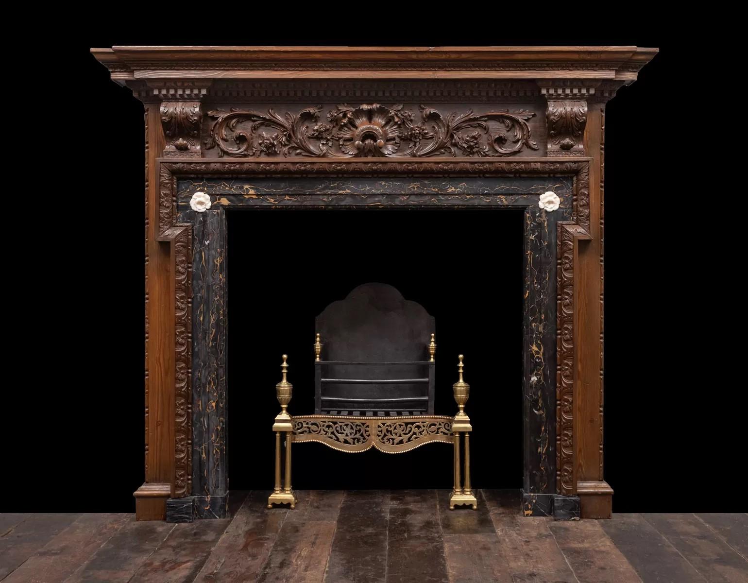 A very good George II carved pine fire surround with Portoro marble interior.
Palladian in style and period, with a well carved Rococo decorated frieze, between two acanthus corbels and under a stepped shelf carved on several layers. 

Circa 1750