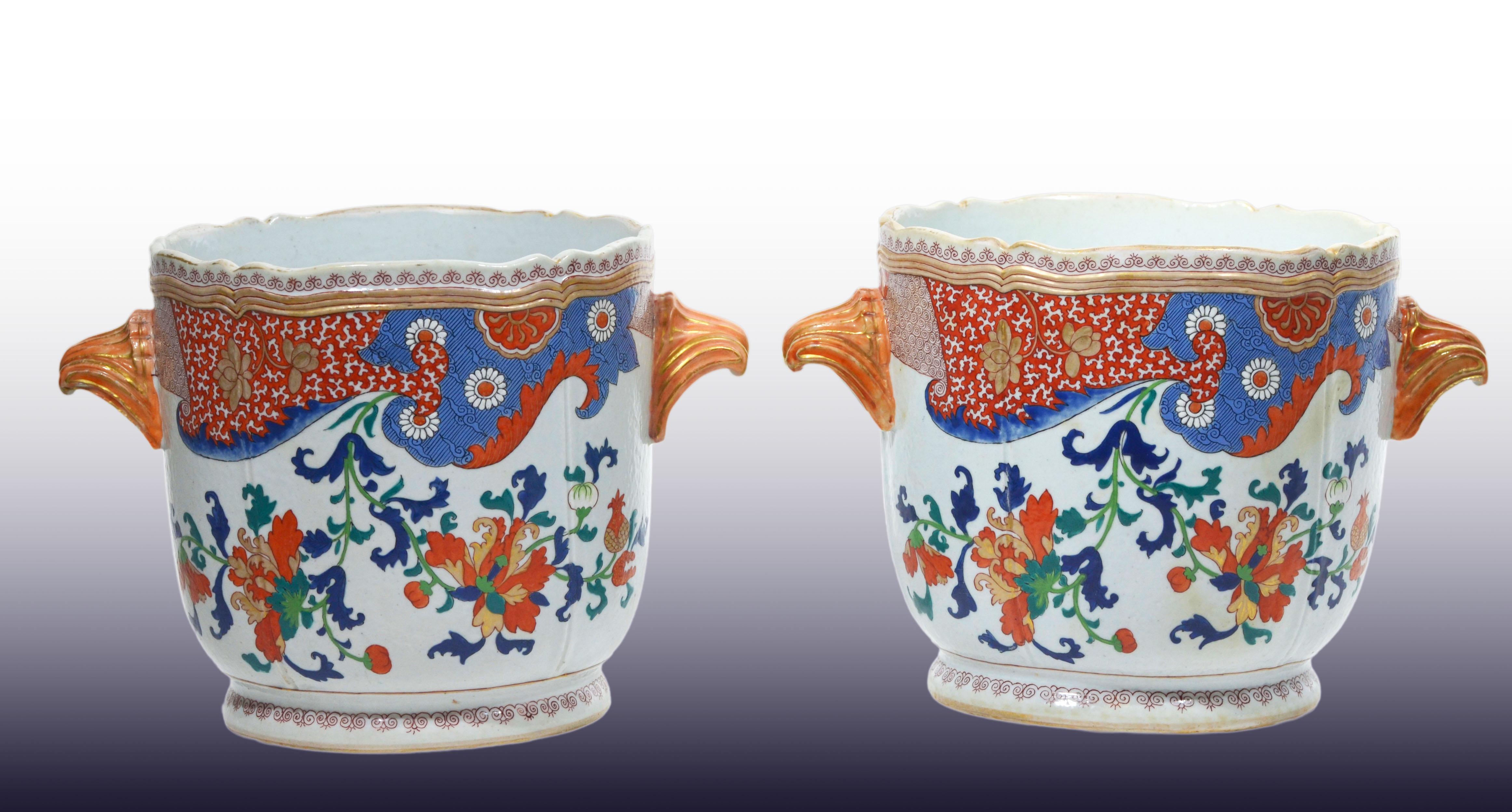 A Very Large and Unusual Pair of 18th Century Chinese Imari Pattern Wine Coolers.  Each of rounded cylindrical form with a slightly everted scalloped rim and a short, waisted foot. The bodies are fitted with applied gilt porcelain handles modeled in