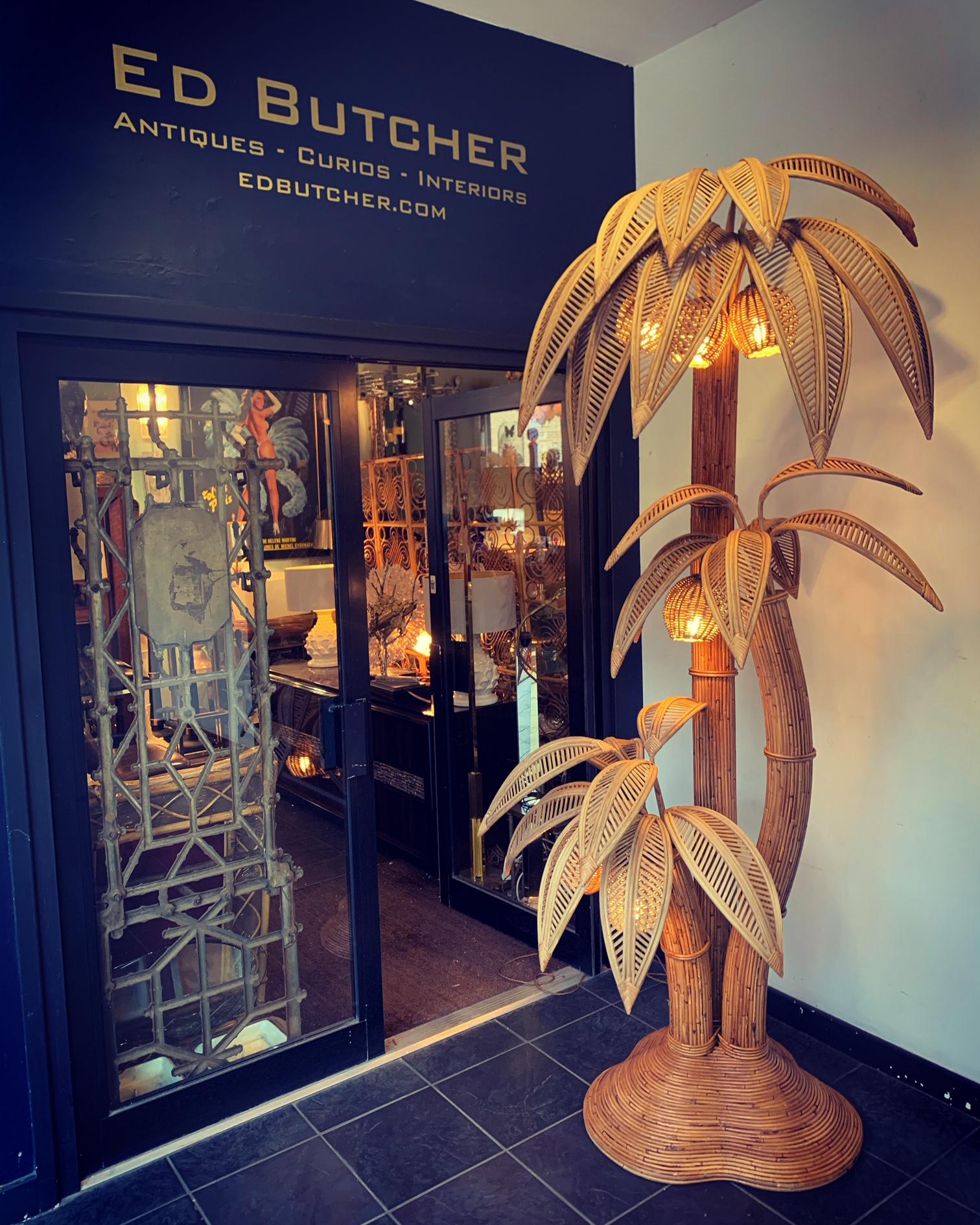 A stunning very large, bamboo and rattan 3 stemmed palm tree floor lamp in the style of Mario Lopez Torres with seven coconut lights at differing heights below bamboo leaves. Re wired with antique gold cord flex and PAT tested. 


 