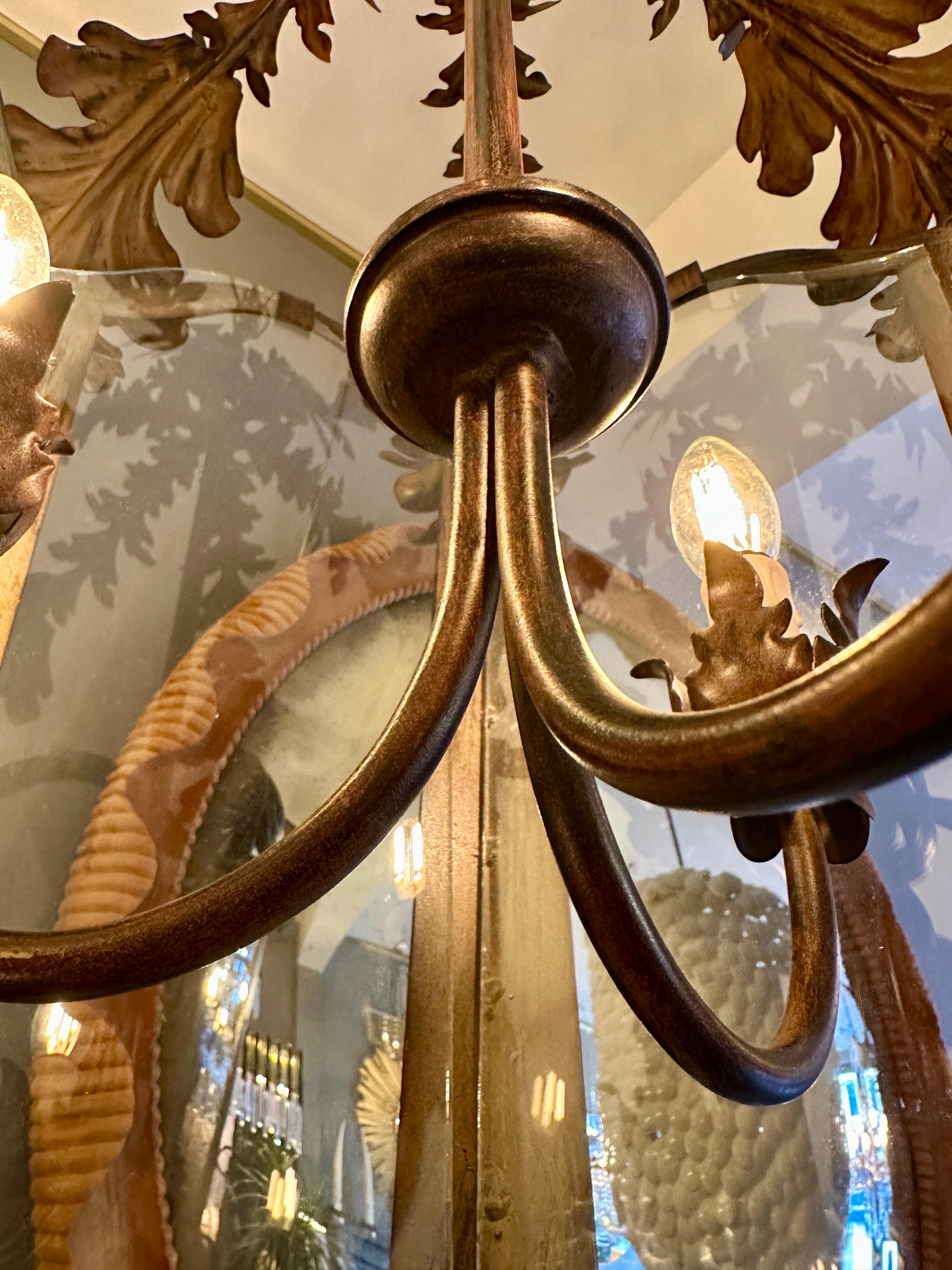 A very large Toleware lantern, hexagonal in shape with scrolled acanthus leaf  decoration. The canopy an elaborate foliate design. Patinated bronze, lightly distressed, and very well done. Inside a 3 arm branch with foliate decorated bulb