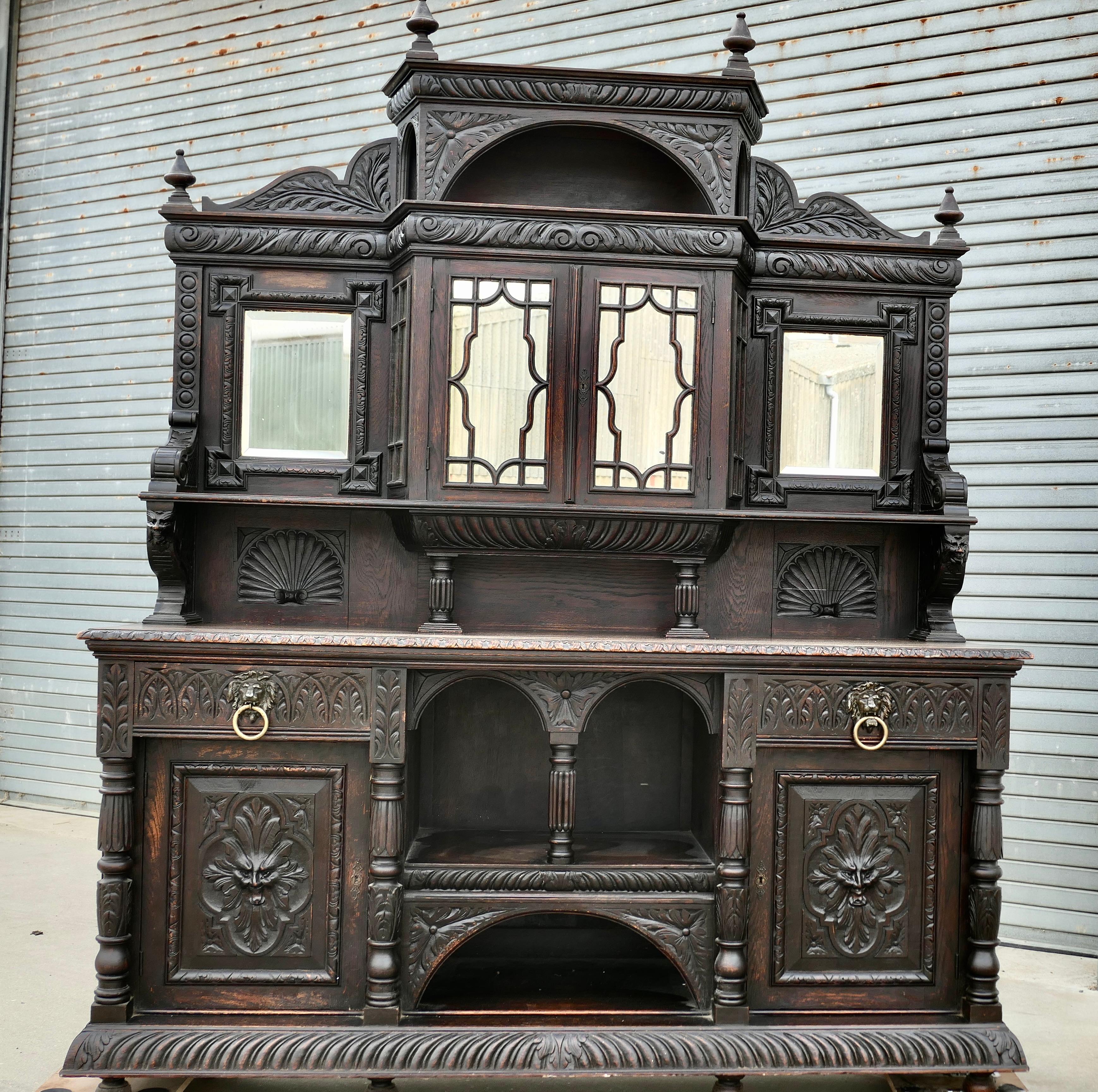 A Very Large Carved Oak Green Man Sideboard
This superbly Gothic piece is decorated in a country house style, as there are many patterns to the carvings including faces of lions  and the Green Man
The dresser base has 2 large cupboards with drawers