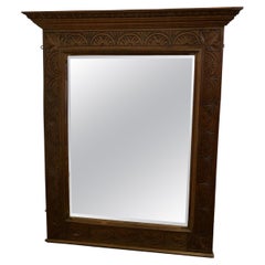 A Very Large Carved Oak Overmantel or Wall Mirror