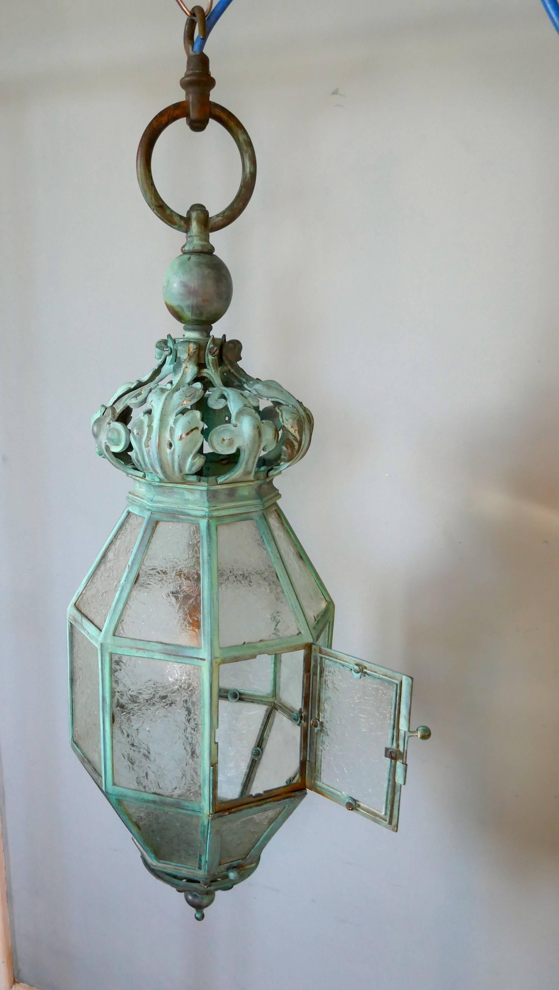 A very large decorative copper lantern

This copper hall lantern has a superb Verdigris patination, the lamp has a wonderful crackled frosted glass set into its eight sides, which sparkles when the light shines through the 24 shaped panes
(one of