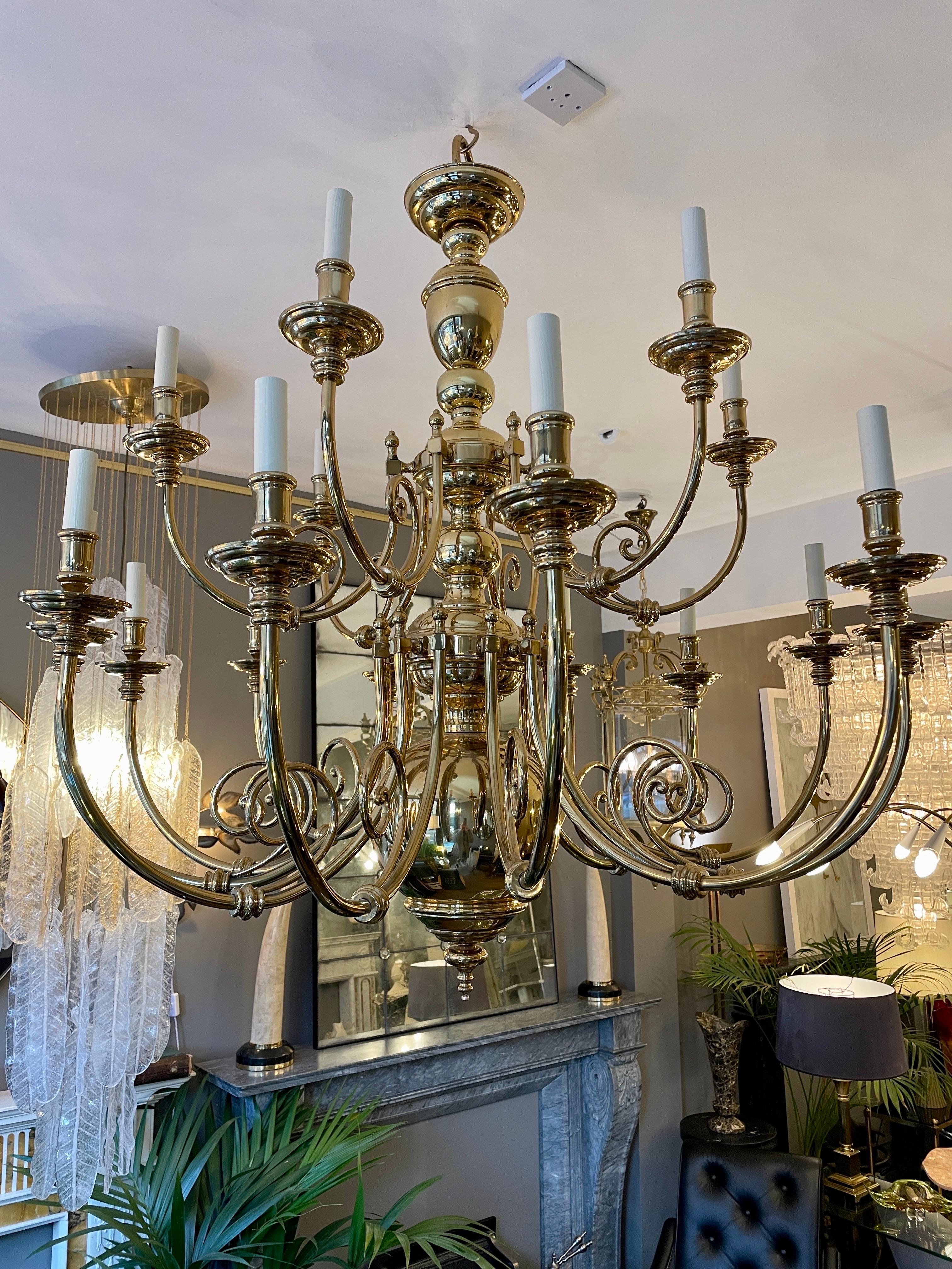 A large and impressive Flemish 18th century style chandelier with 18 arm. The baluster stem supporting two tiers of arms 12 to lower and 6 above. All the arms with matching scroll work, turned nozzles and drip pans. 

The chandelier will be re