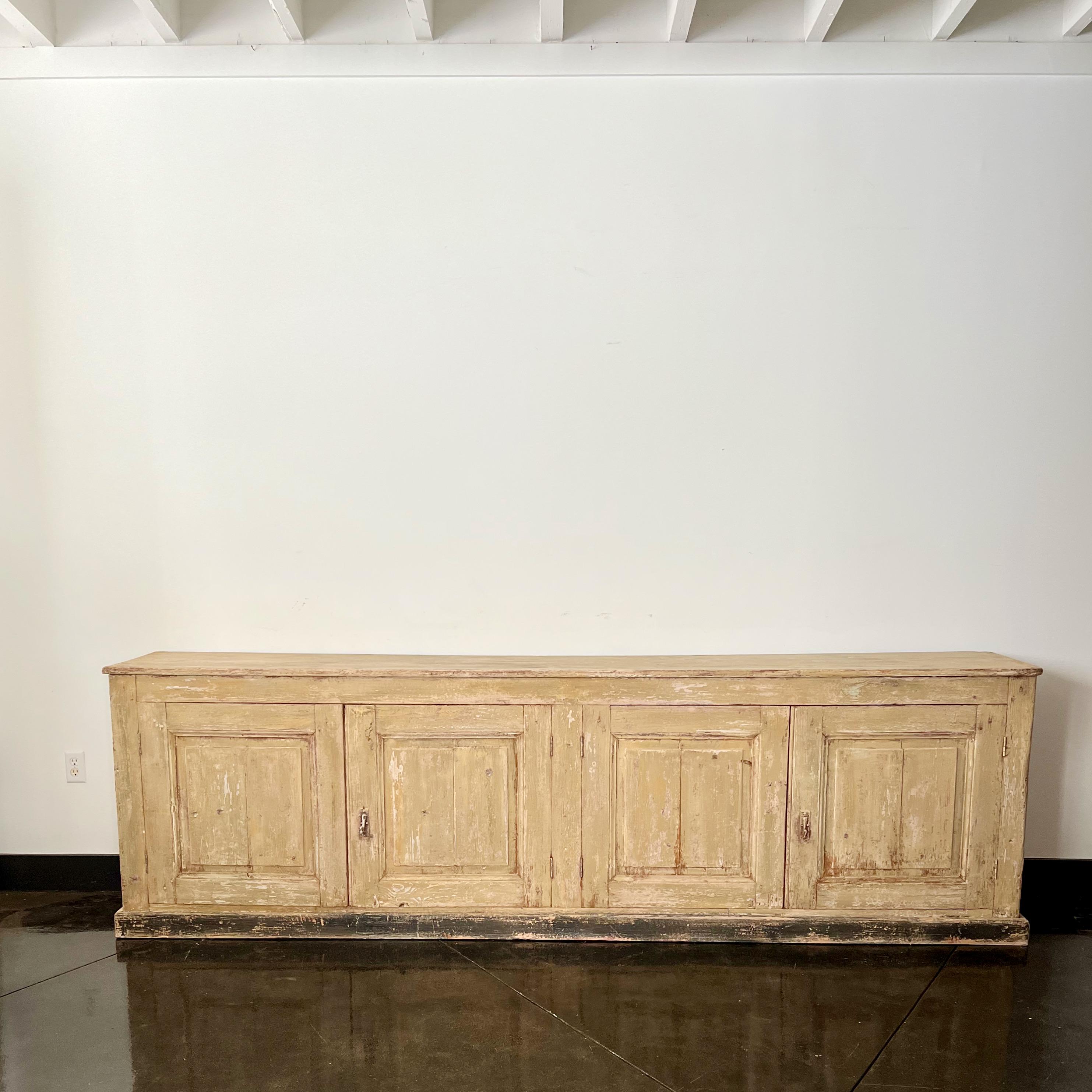 A very large four door 19th century Italian sideboard in original lot of time worn patina with amble storage and original hardwares.
